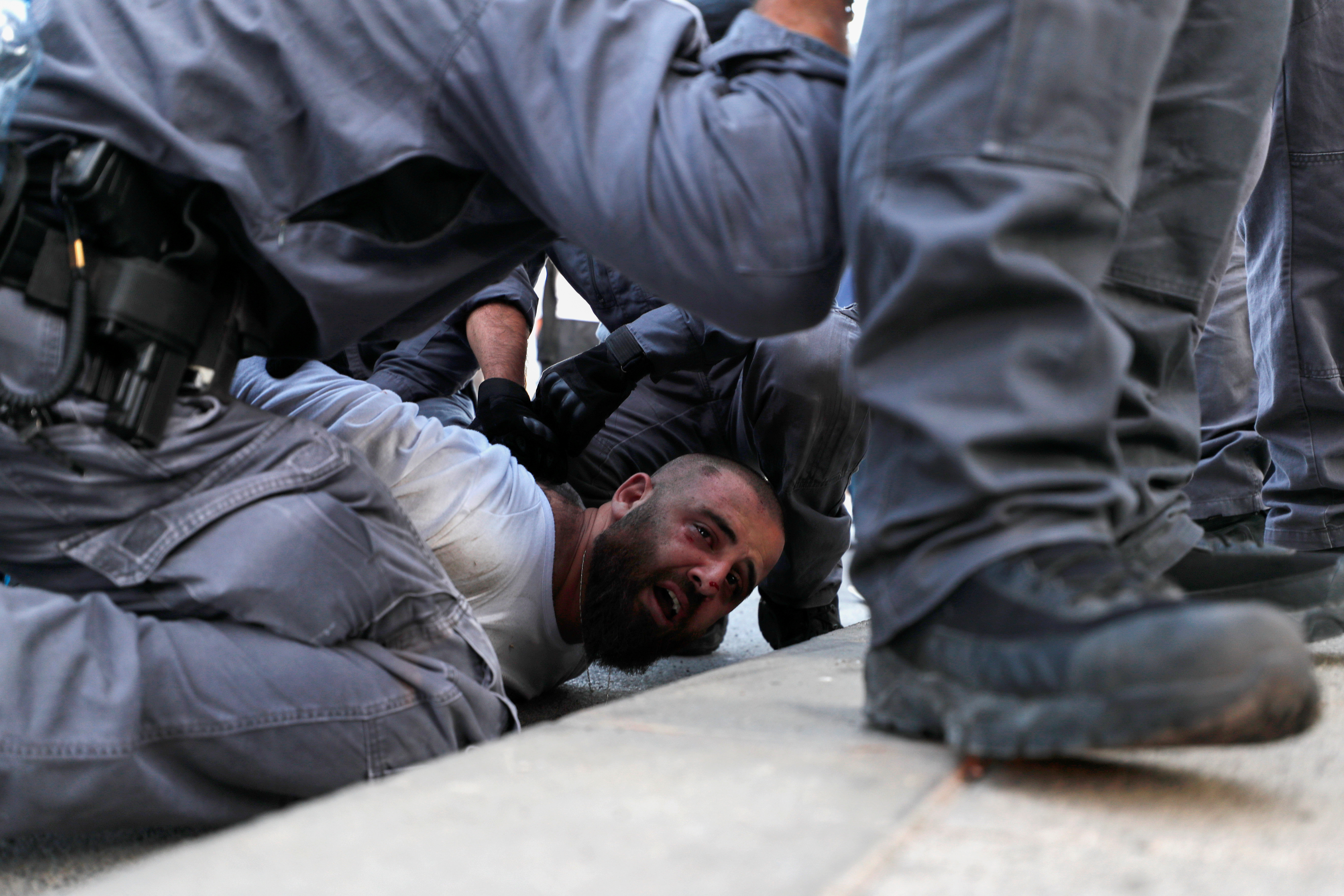 Israeli security forces detain a Palestinian man during a protest against Israel held after a detainee suspected of killing an Israeli teenager in a bomb attack was hospitalized during interrogation, in Jerusalem October 1, 2019. REUTERS/Ammar Awad