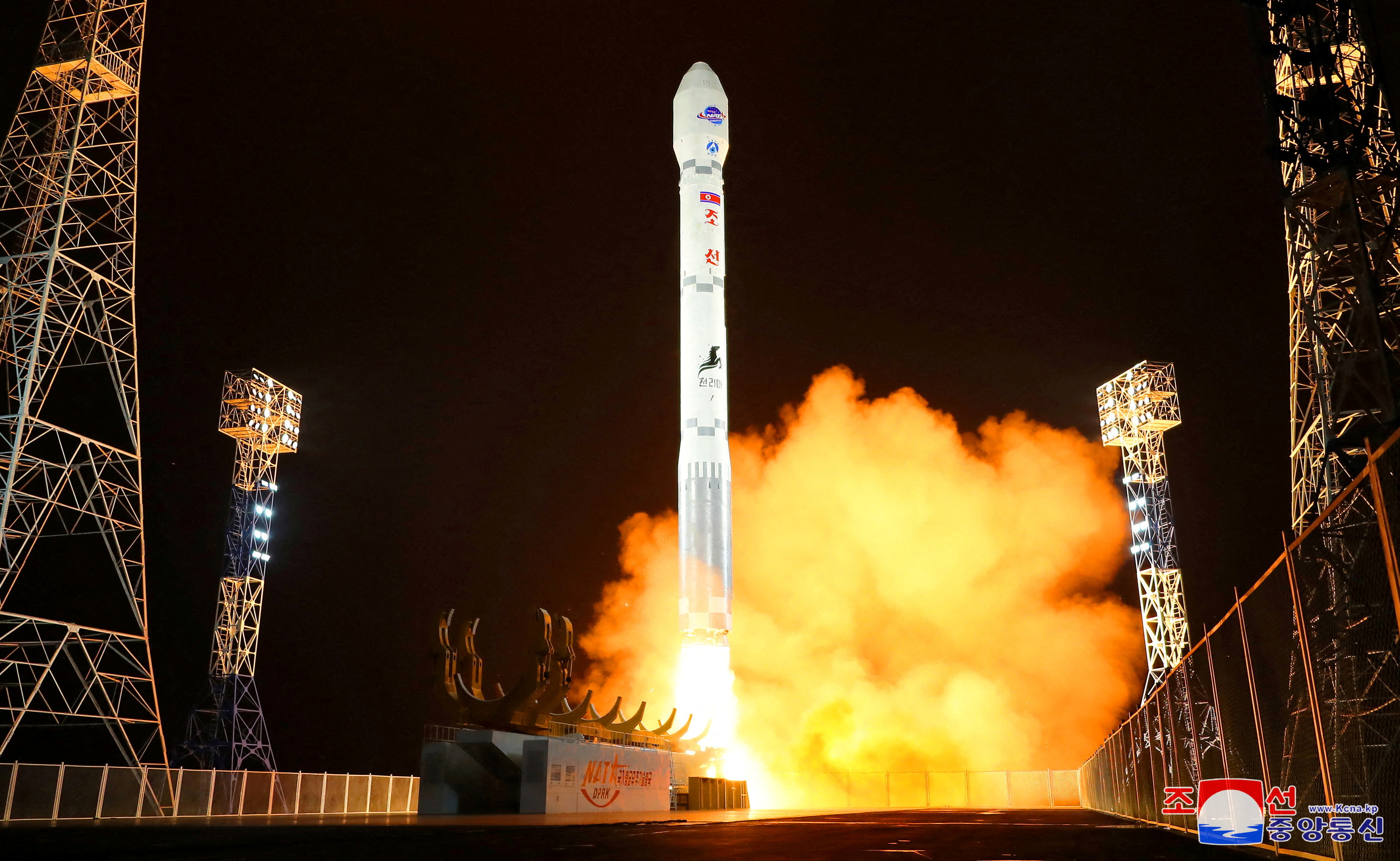 The rocket taking off in amid orange smoke and flame