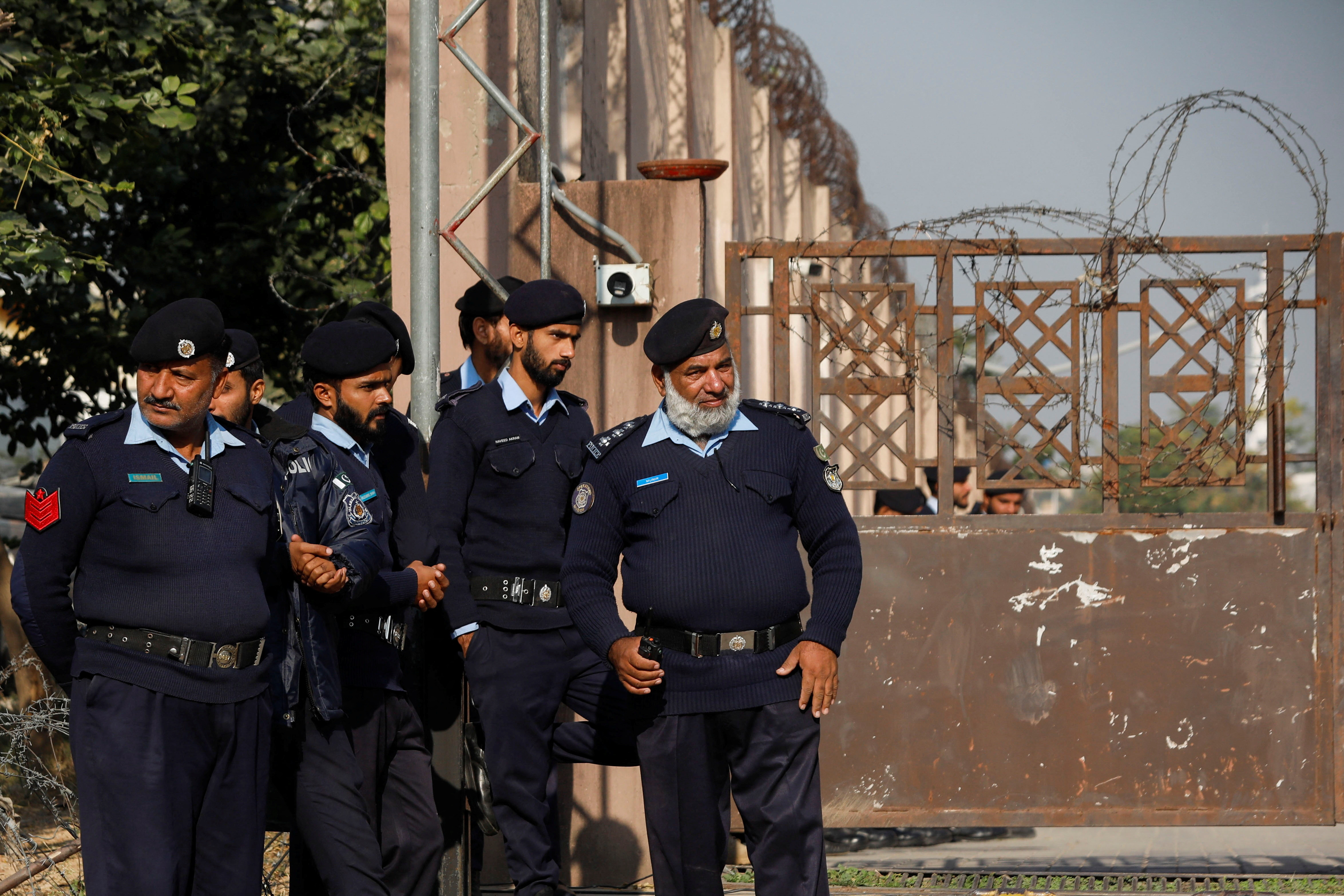 Police officers stand at the entrance of a judicial complex in Islamabad