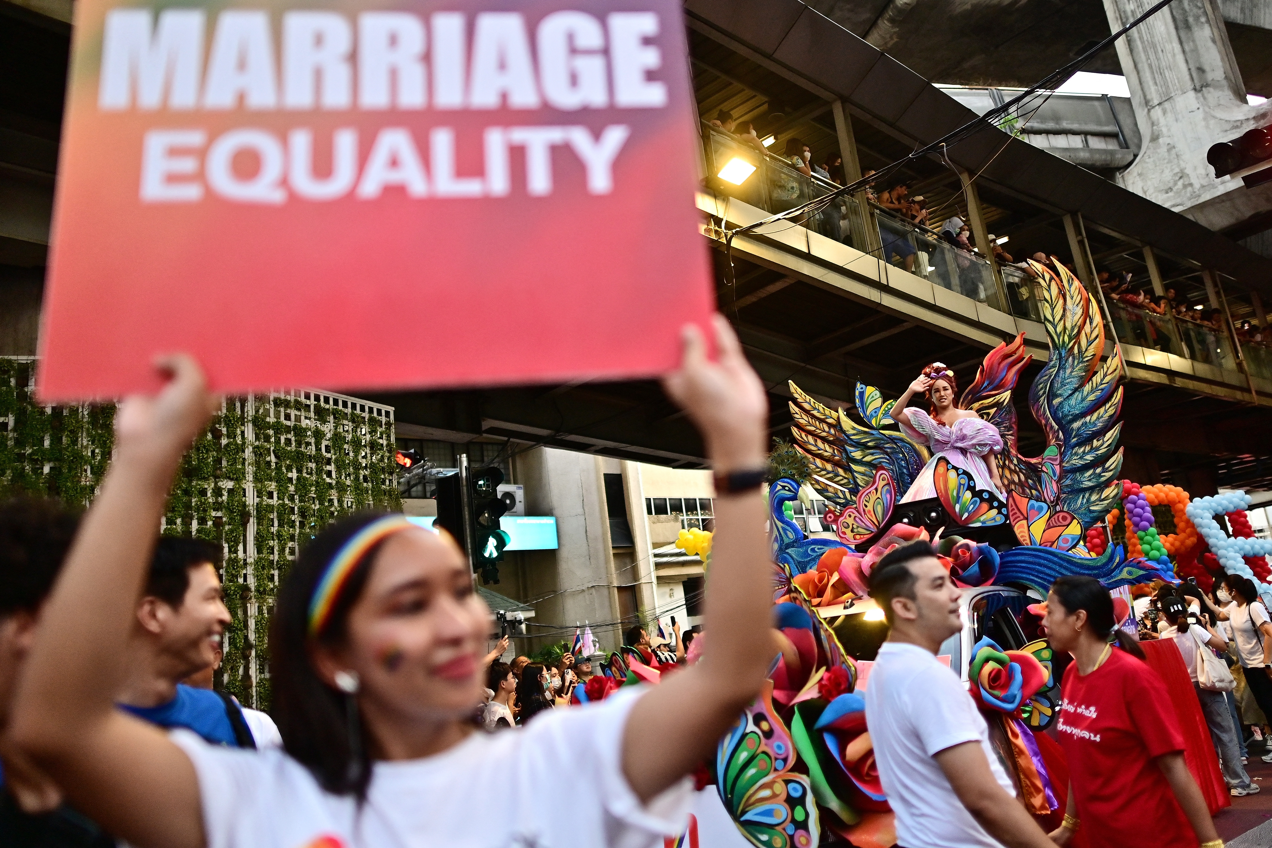 Members of the LGBTQ community take part in a pride march in Bangkok, Thailand in June 2023 [Manan Vatsyayana/AFP]