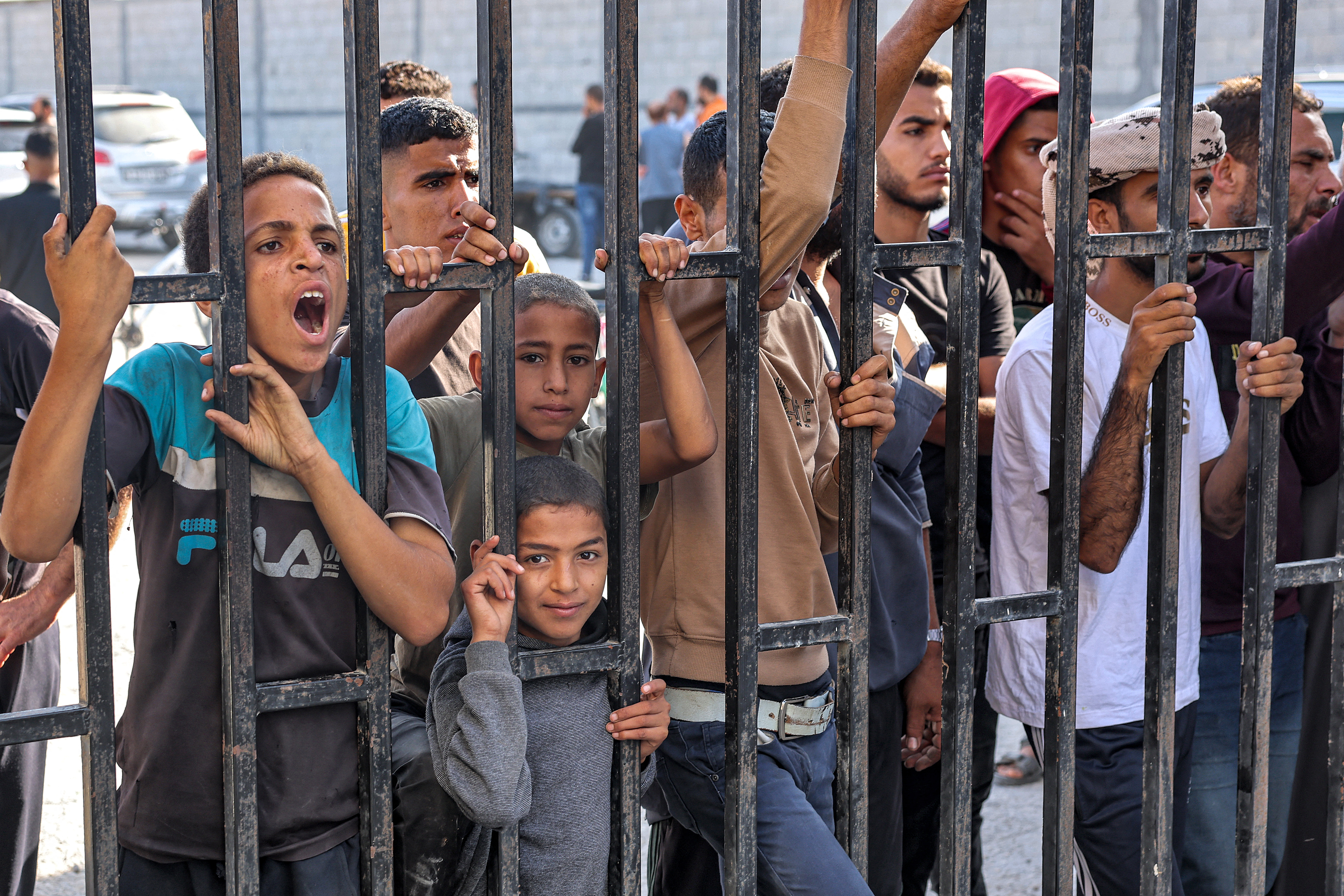 Relatives await the arrival of Palestinian workers who were stranded in Israel