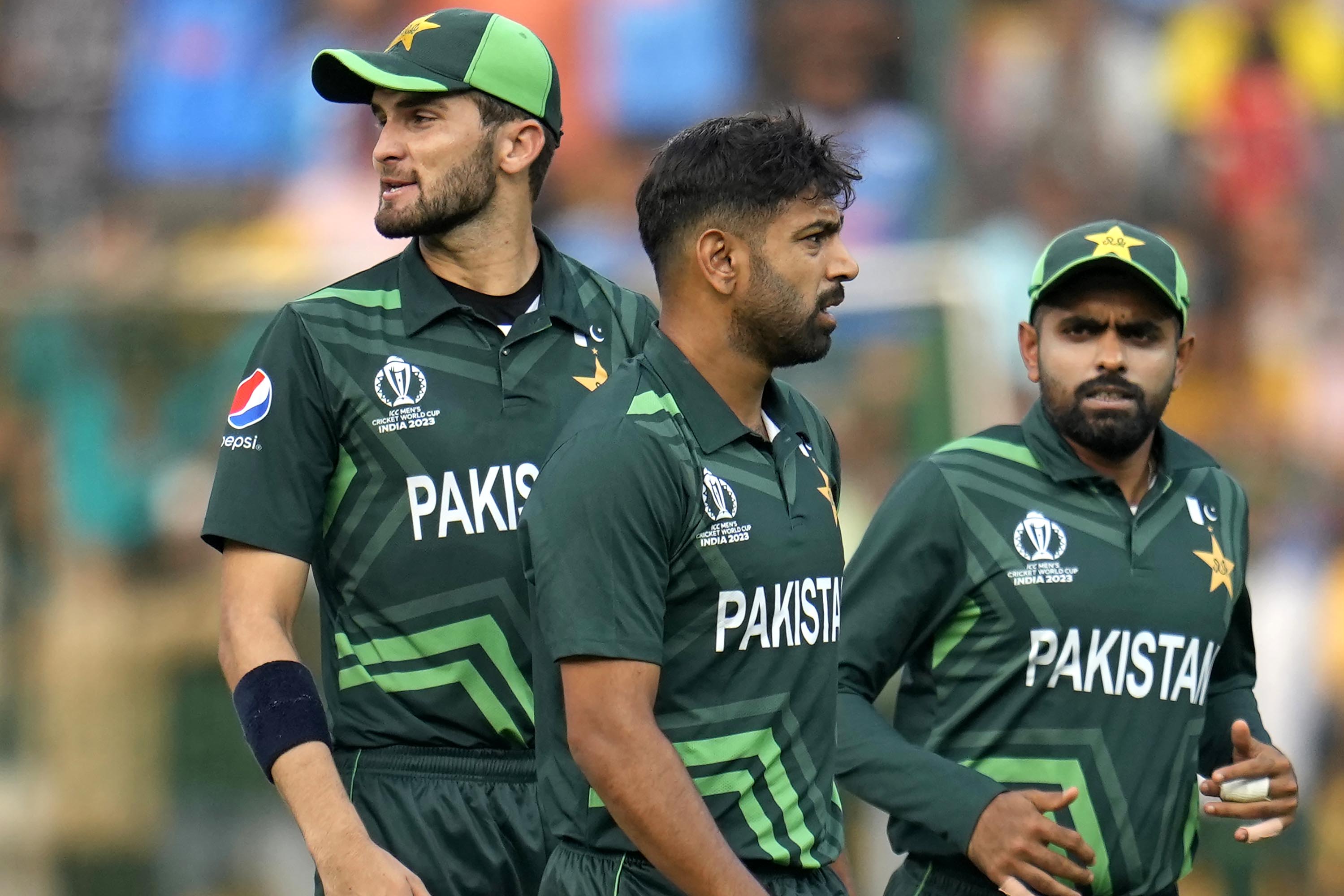 Pakistan's Haris Rauf, center, and teammates celebrate the dismissal of Australia's David Warner during the ICC Men's Cricket World Cup match between Australia and Pakistan in Bengaluru, India, Friday, Oct. 20, 2023. (AP Photo/Aijaz Rahi)