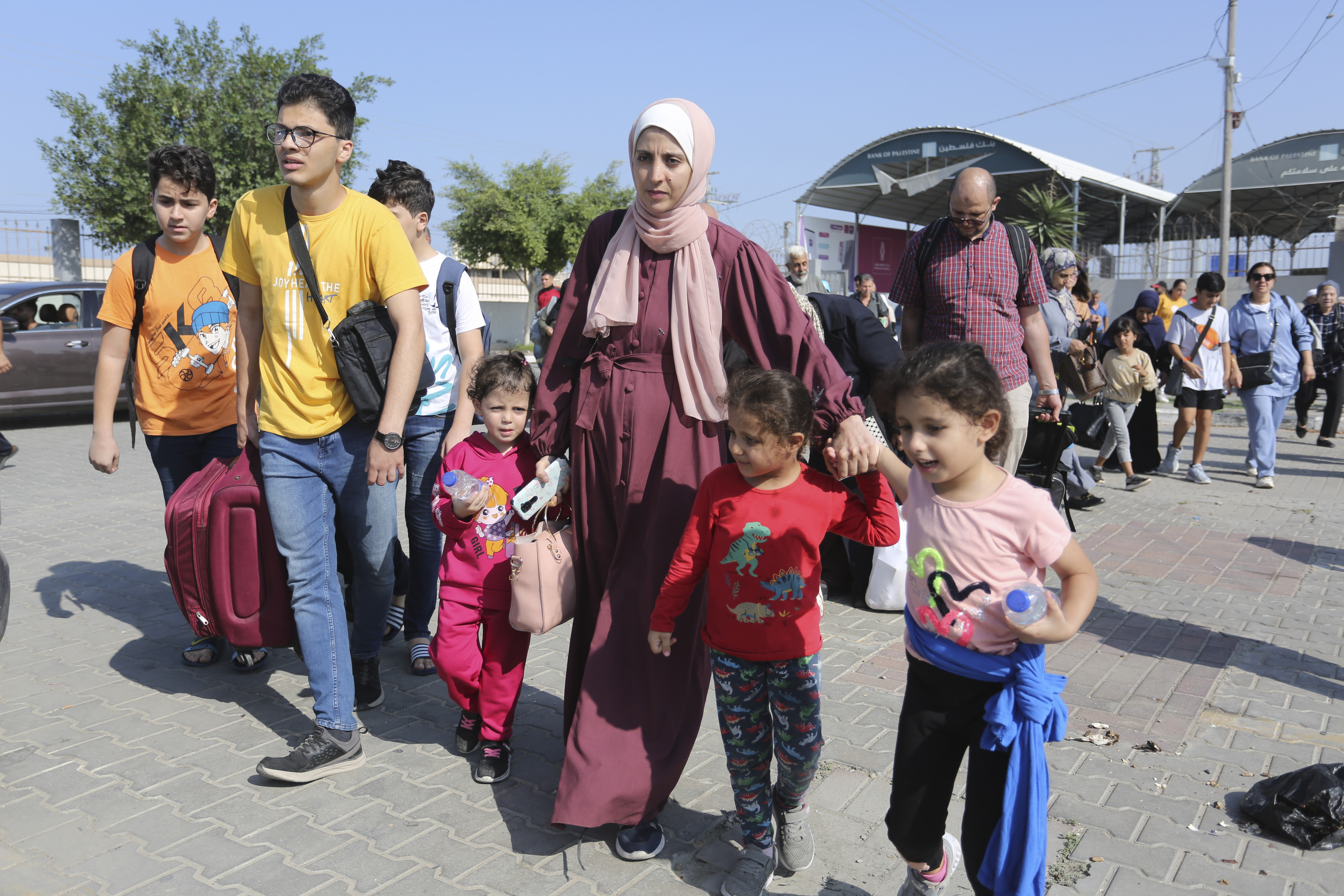 Palestinians cross to the Egyptian side of the border with the Gaza Strip