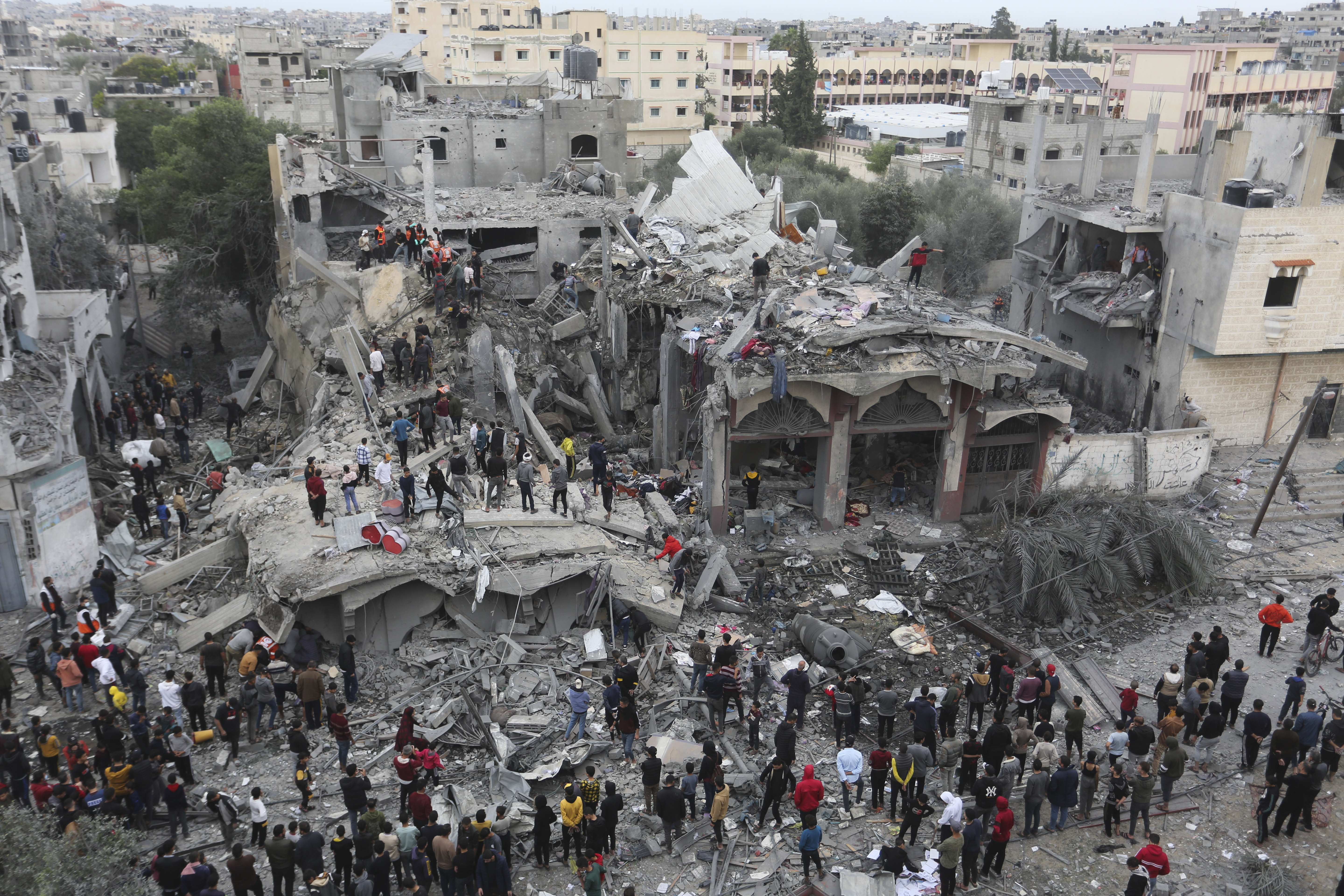 Palestinians search for survivors of the Israeli bombing in Rafah, Gaza Strip