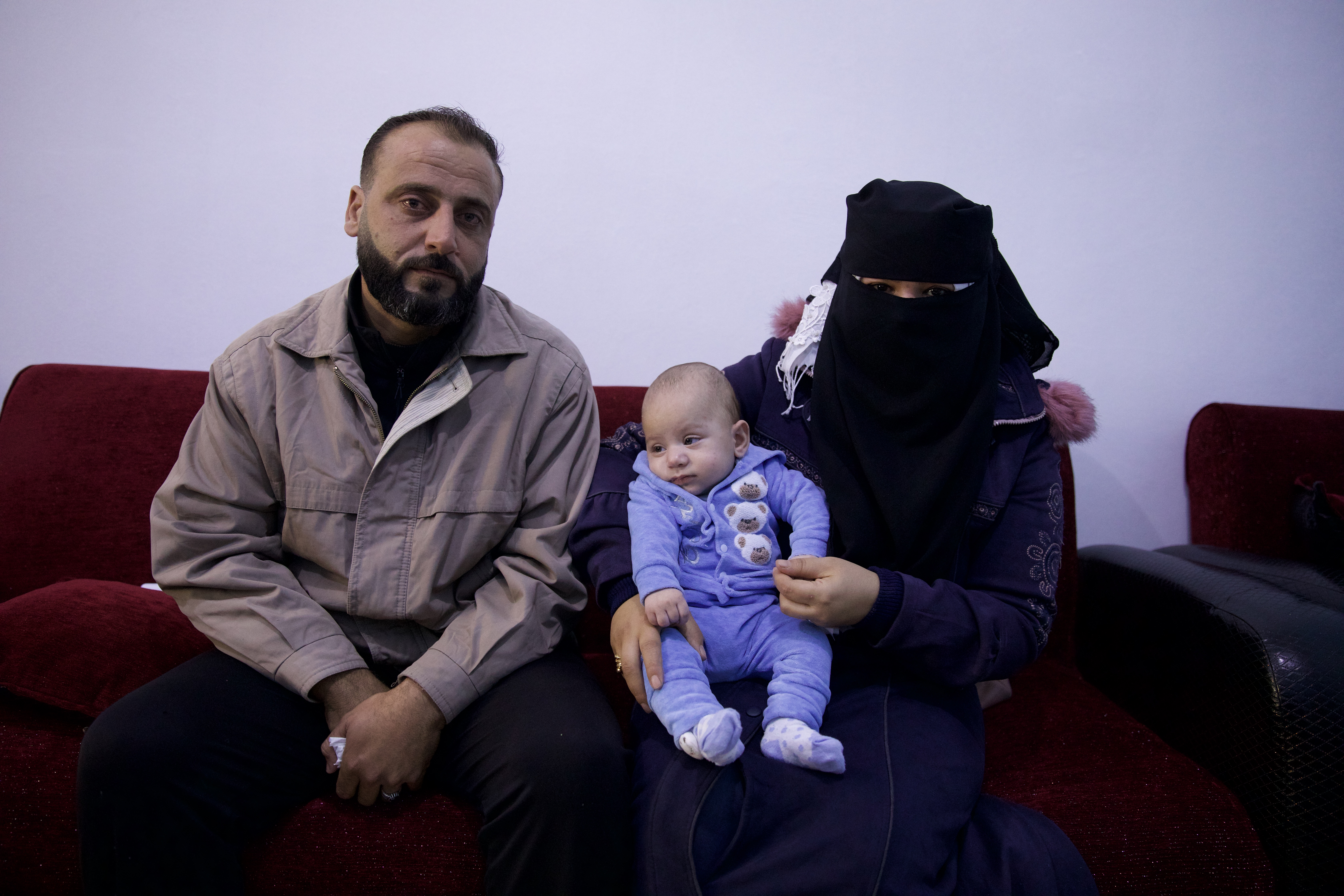 Abdul Khaliq Msalahlou and his wife Khawla Ghazi sit with their new son, Ahmed