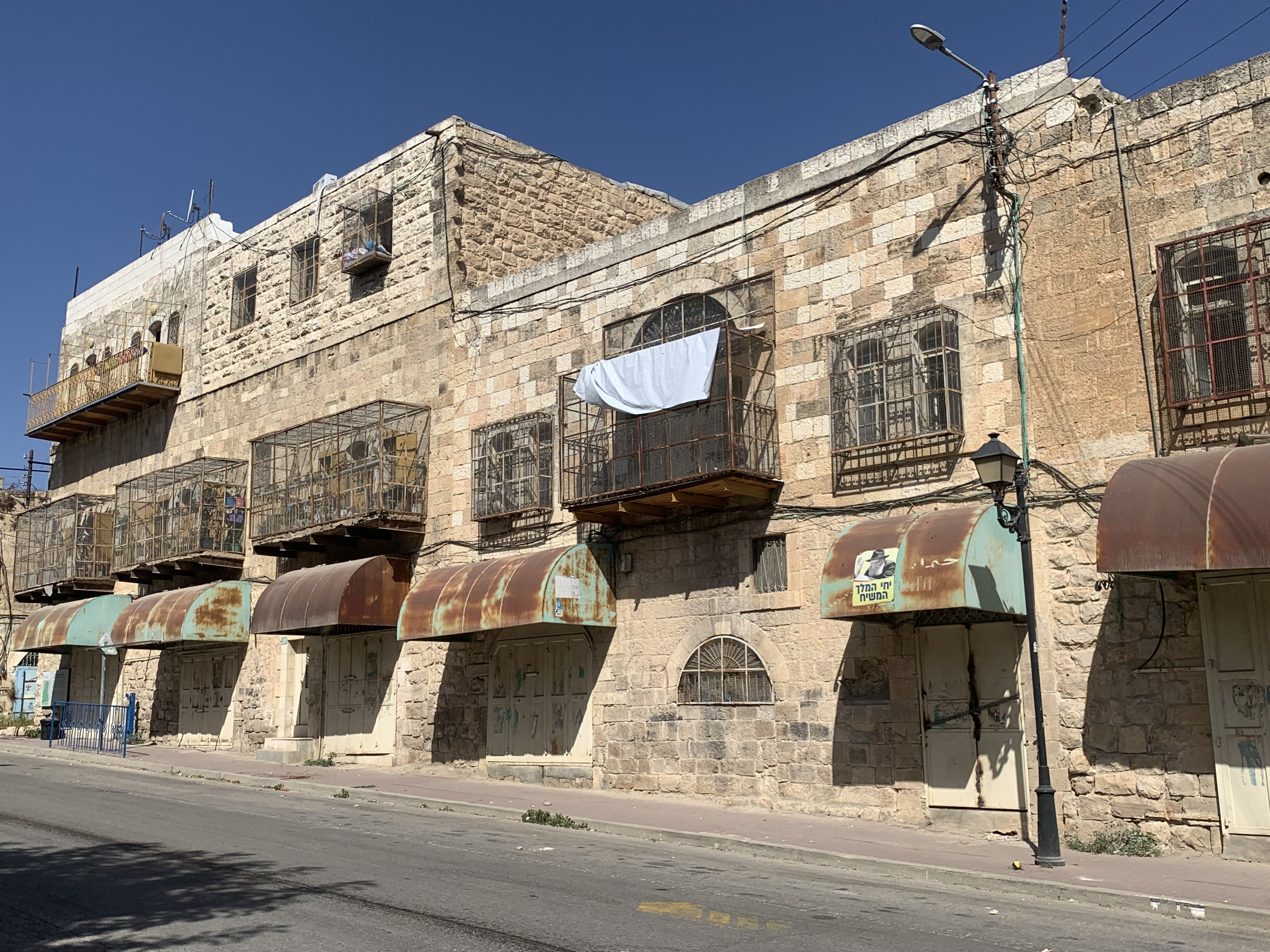 view down a deserted street with old stone buildings