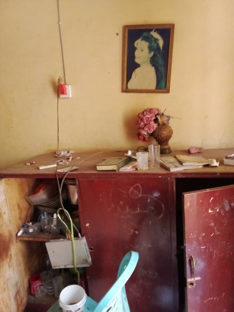 A portrait remains on the wall of a home looted by RSF in Mojahed’s neighbourhood in Omdurman, Sudan [Al Jazeera]