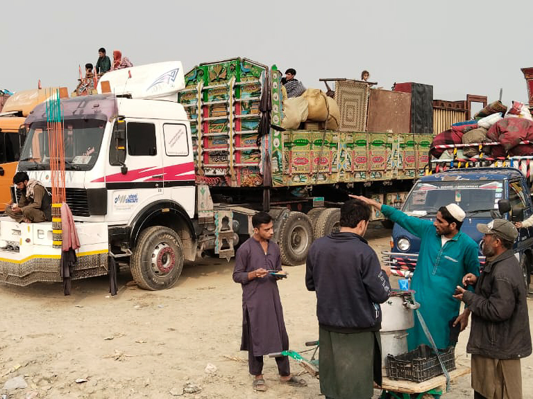 Afghan refugees waiting with their luggage for clearance from custom officials
