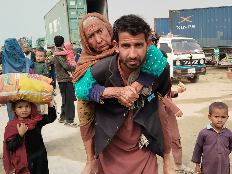 Syed Muhammed carrying his ailing mother on his shoulders