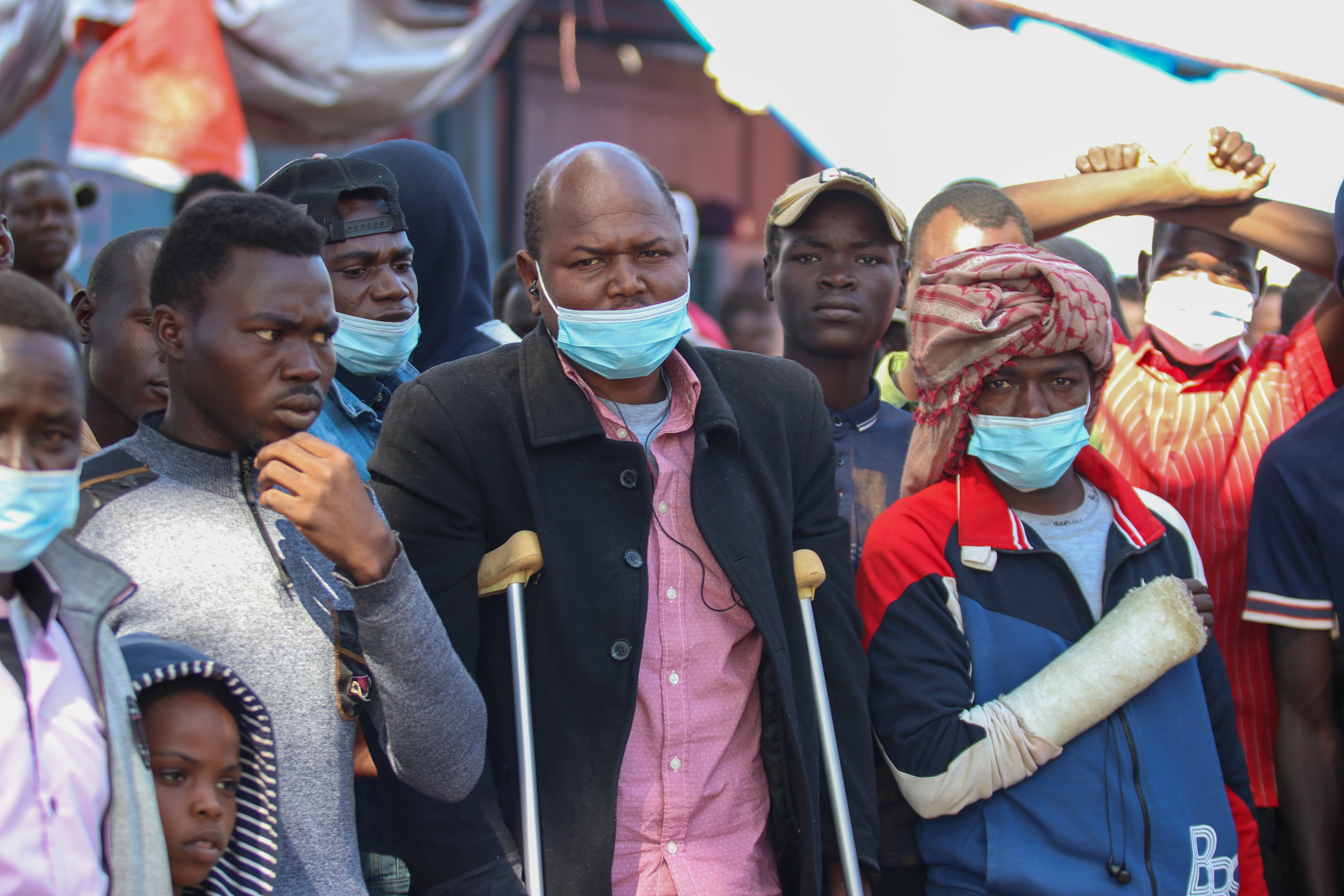 William Siyee, centre, on crutches, managed to escape his kidnappers