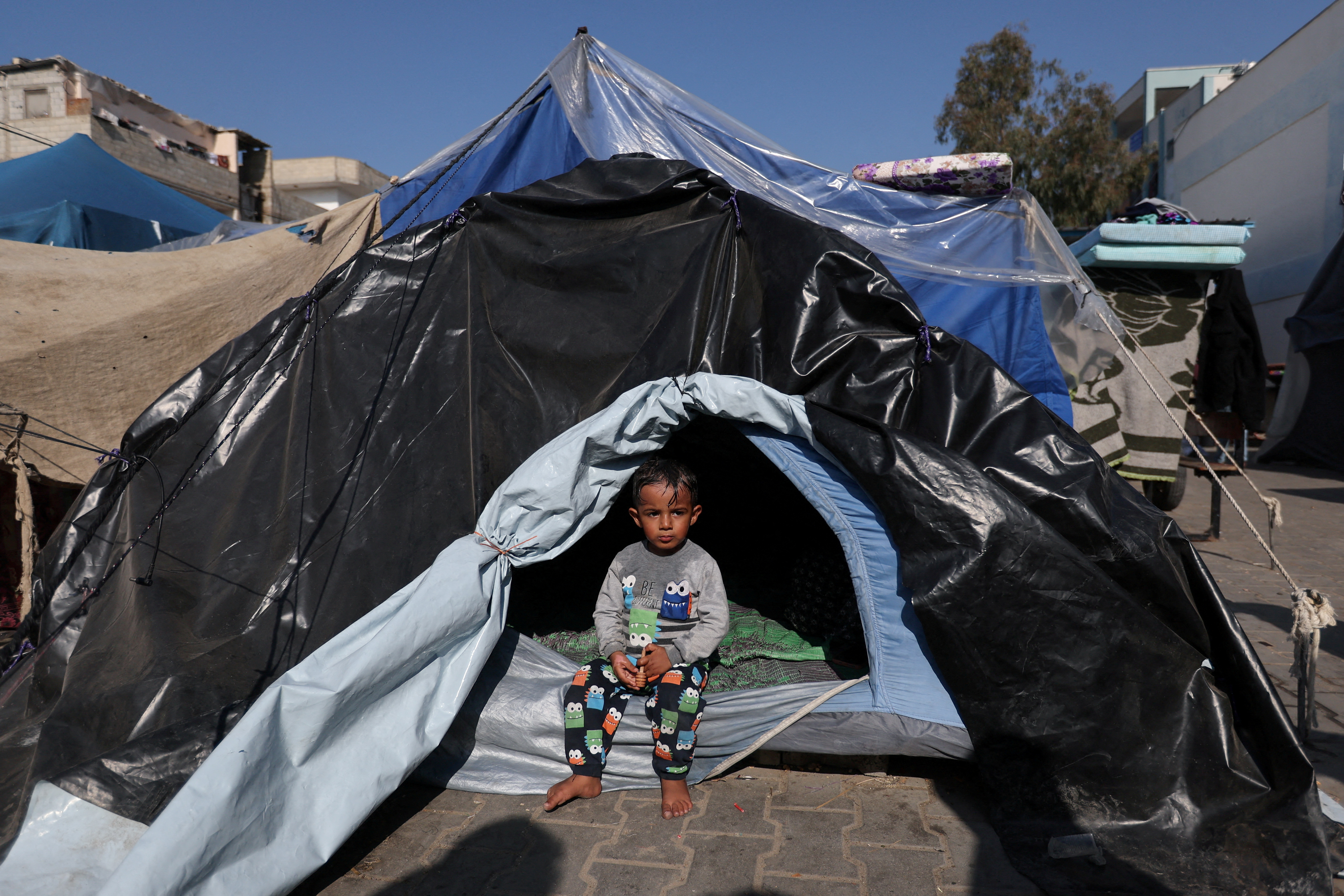 A child sits in a tent in Khan Younis, in the southern Gaza Strip.