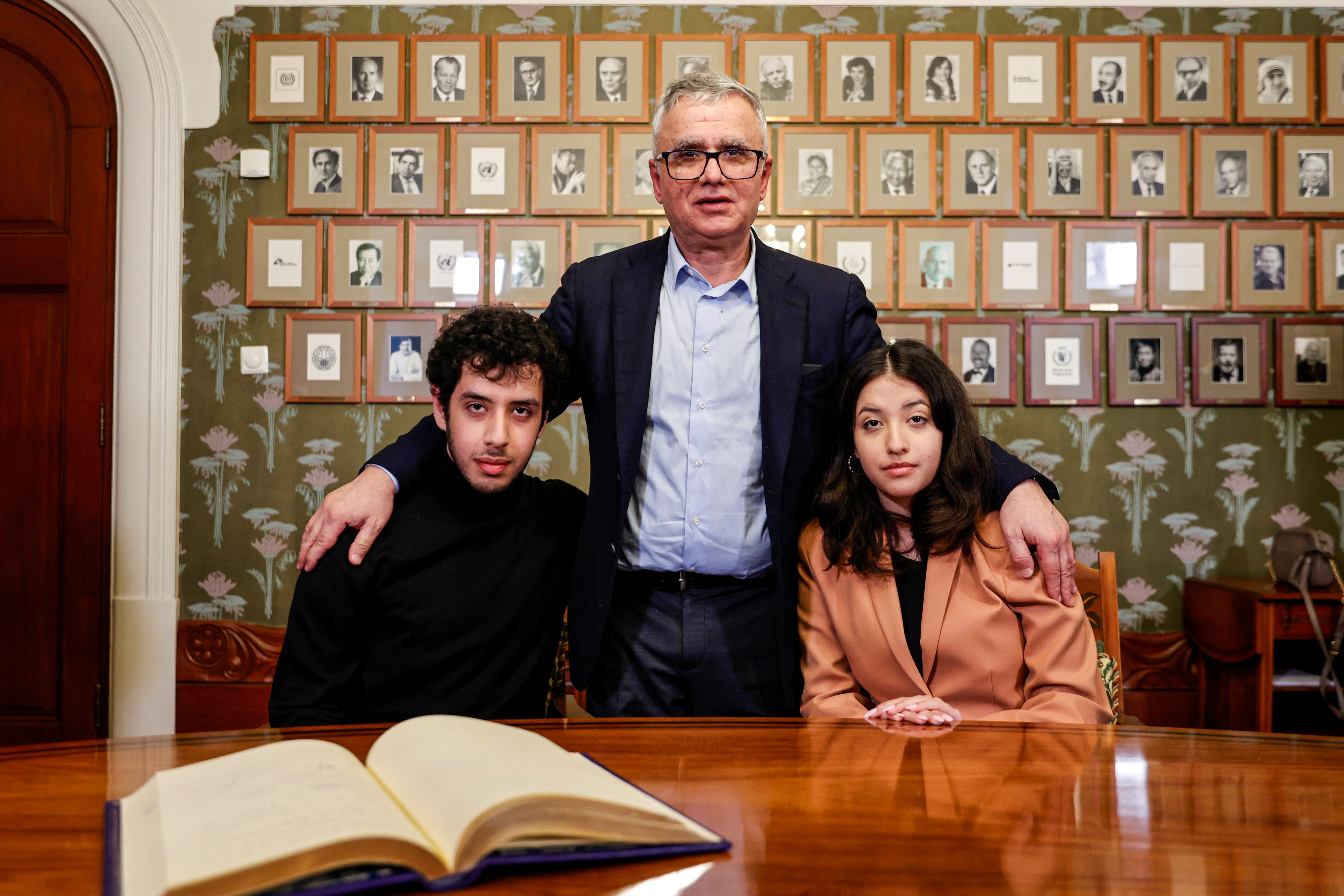 Taghi Rahmani, centre, with twins Kiana and Ali after signing the guest book at the Nobel Institute in Oslo, Norway, on December 9, 2023