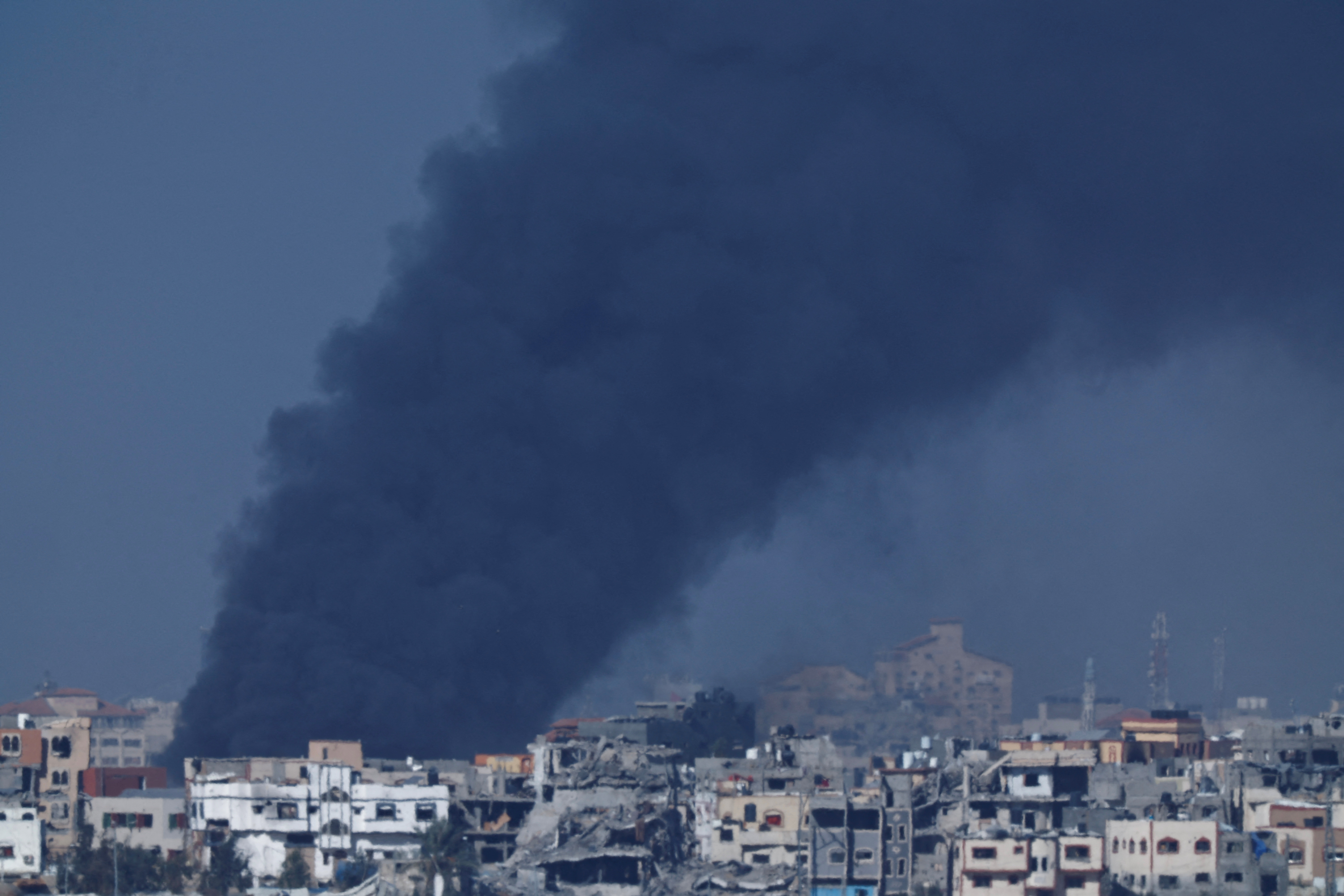 Smoke rises over Gaza, amid the ongoing conflict between Israel and the Palestinian Islamist group Hamas, as seen from southern Israel, December 11