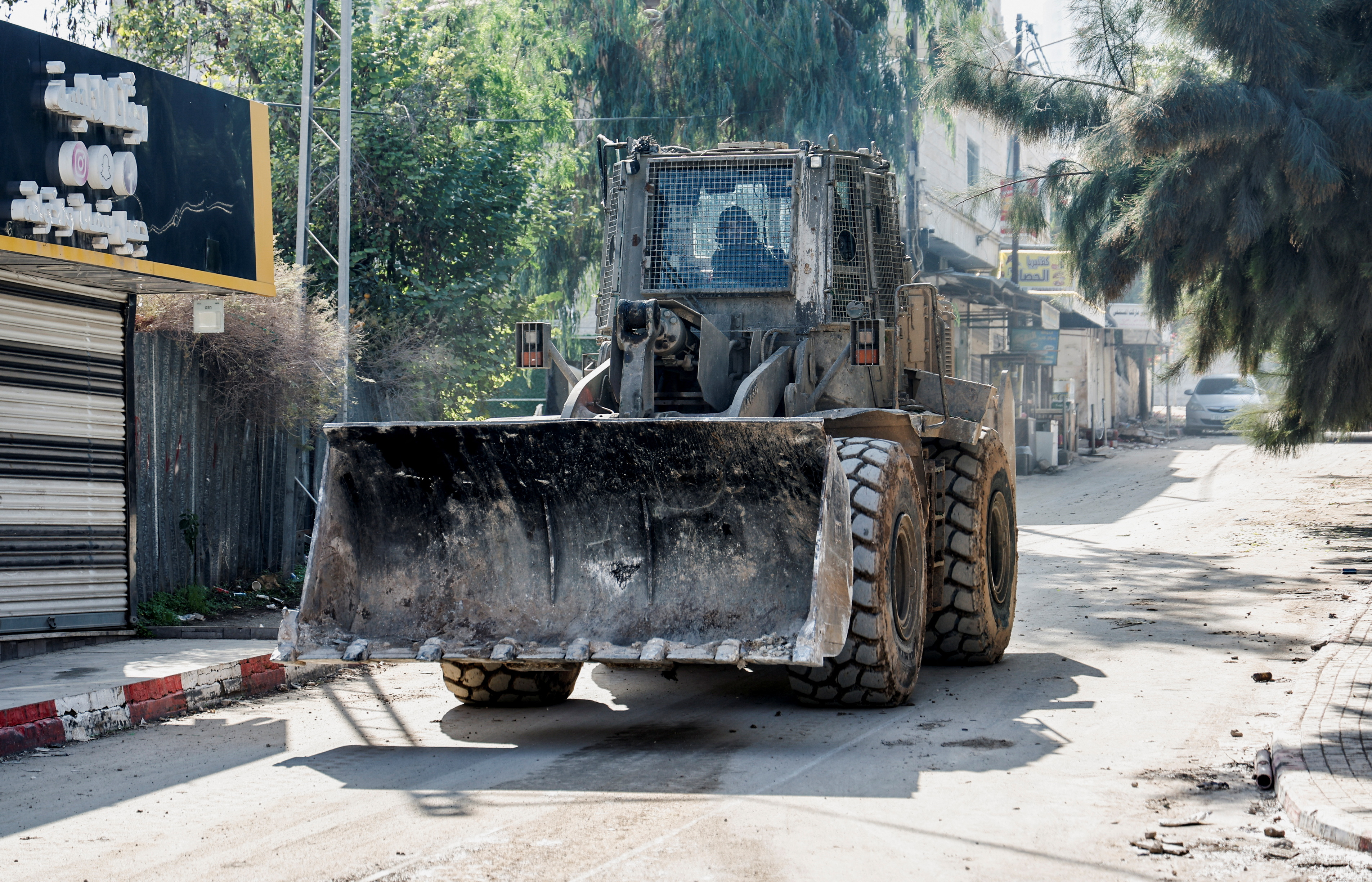 An Israeli army bulldozer manoeuvres on a road during a raid in Jenin in the Israeli-occupied West Bank on December 12, 2023
