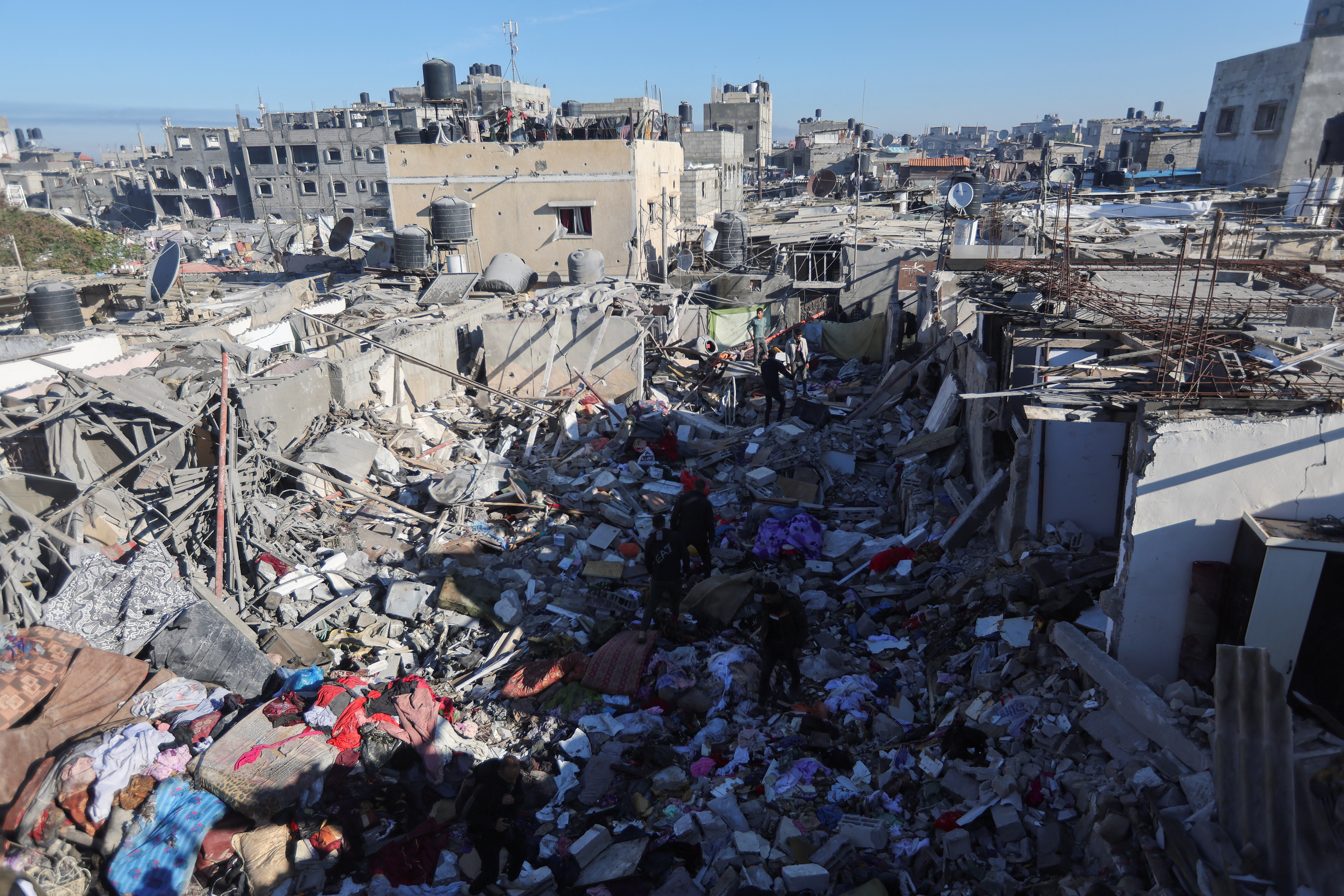 Palestinians inspect the site of an Israeli strike on a house in Rafah in the southern Gaza Strip