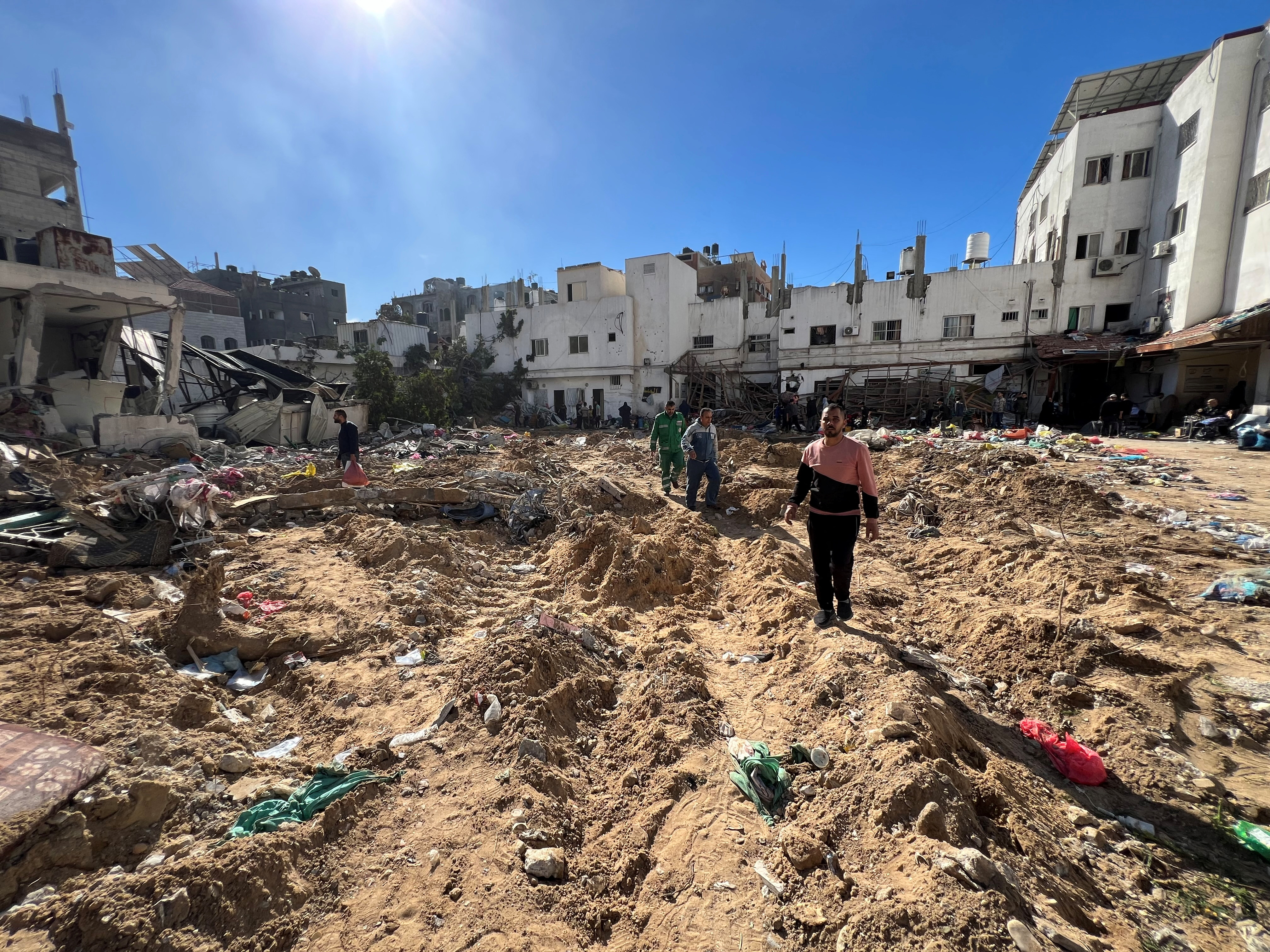 Palestinians inspect the damage following an Israeli raid at the Kamal Adwan Hospital in the northern Gaza Strip