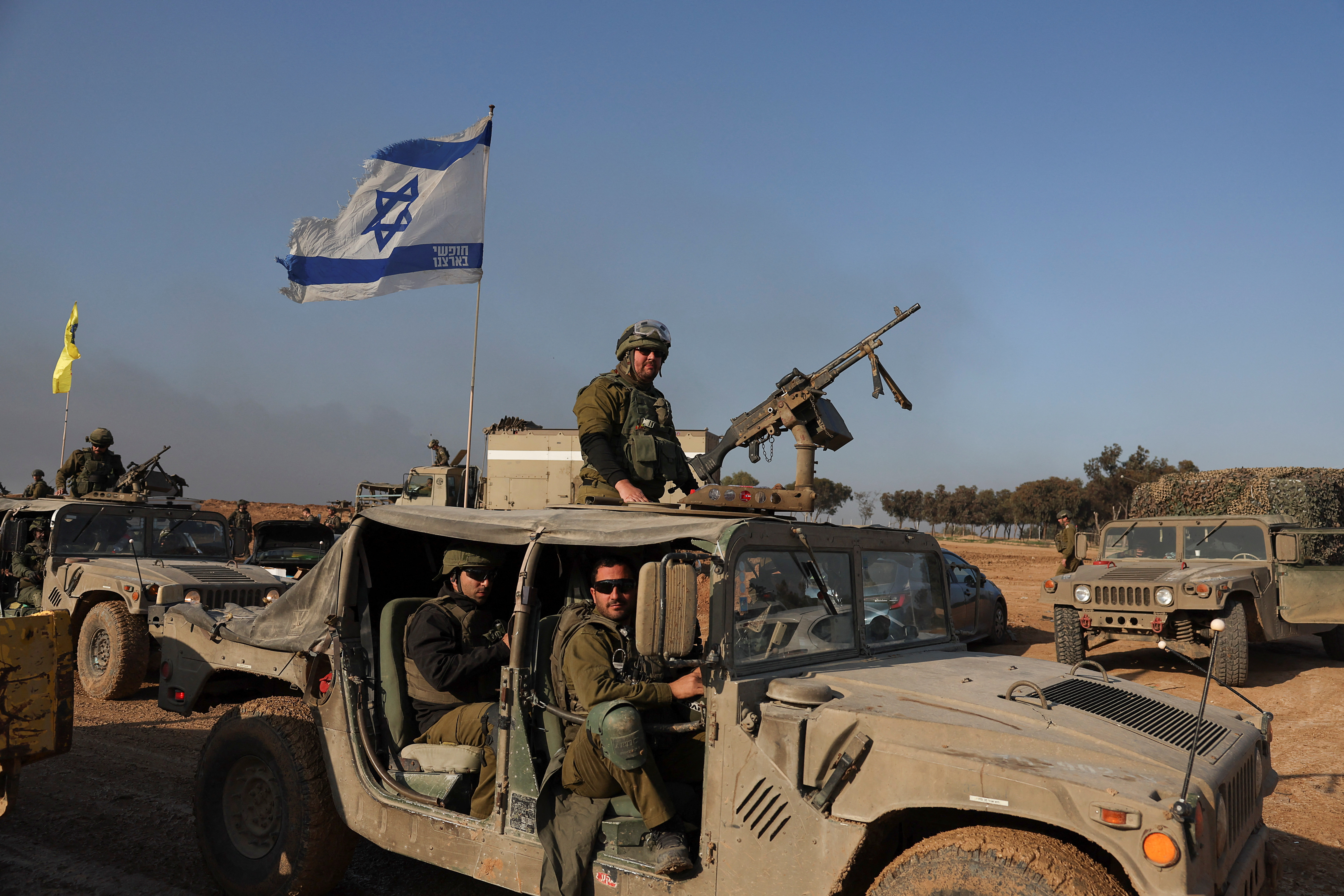 Israeli soldiers sit in a military vehicle, amid the ongoing conflict between Israel and the Palestinian Islamist group Hamas, near the border with Gaza, in southern Israel, December 18, 2023.