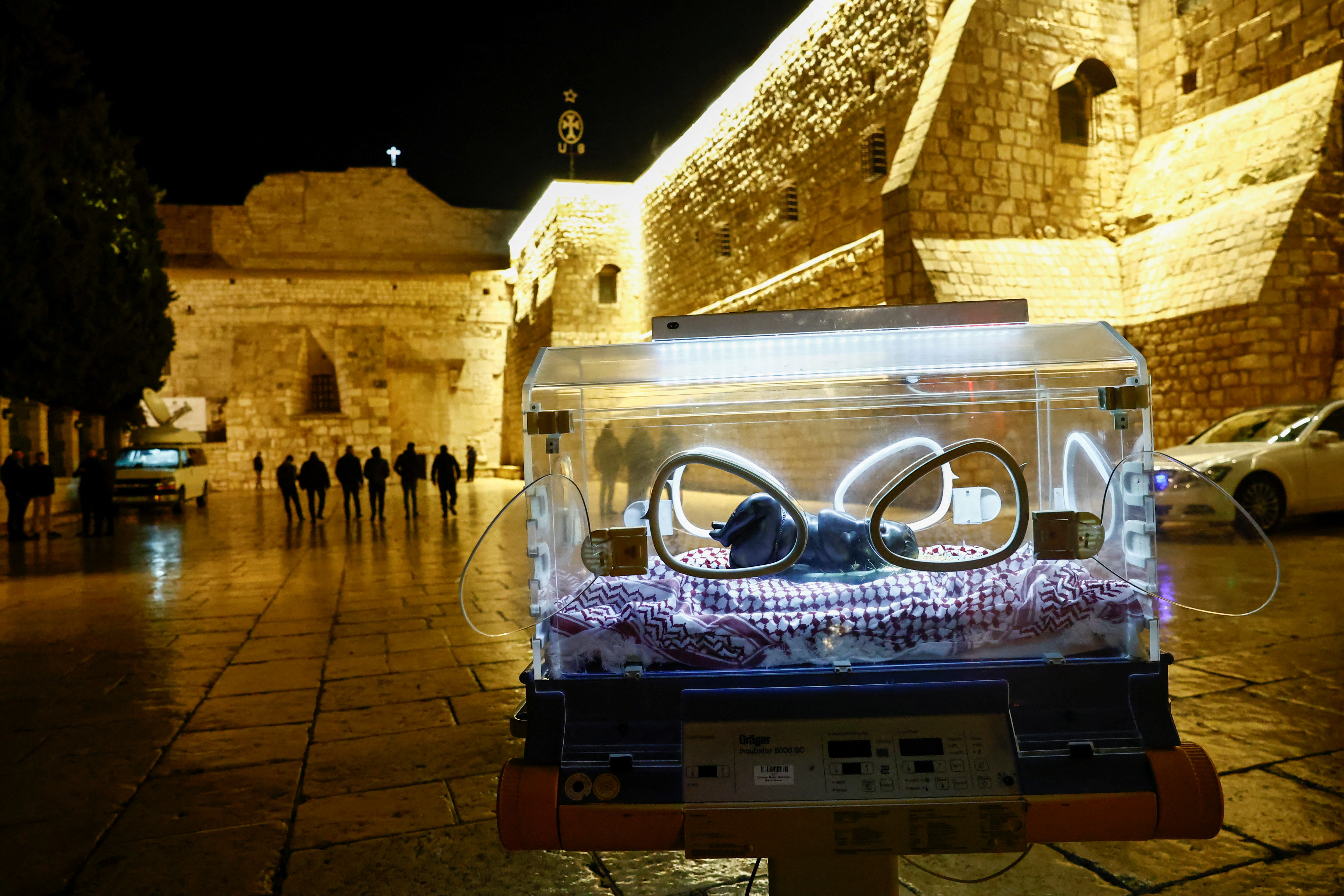 An installation by Rana Bishara shows a figure of baby Jesus, made by Sana Fara Bishara, inside an incubator in front of the Church of the Nativity in Bethlehem