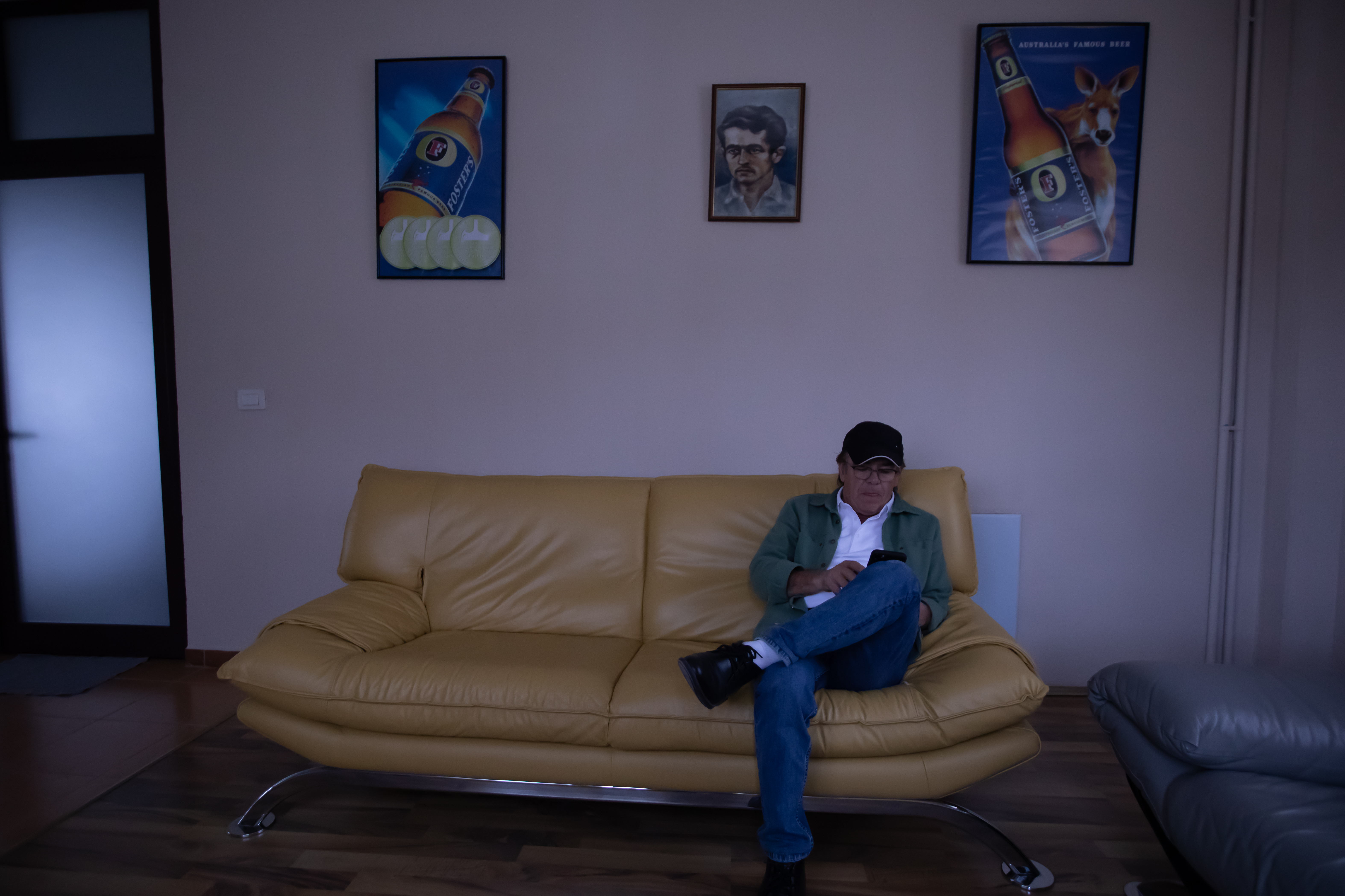 Bajram sits in the lobby of the local TV station he set up in Pogradec after his return from Australia