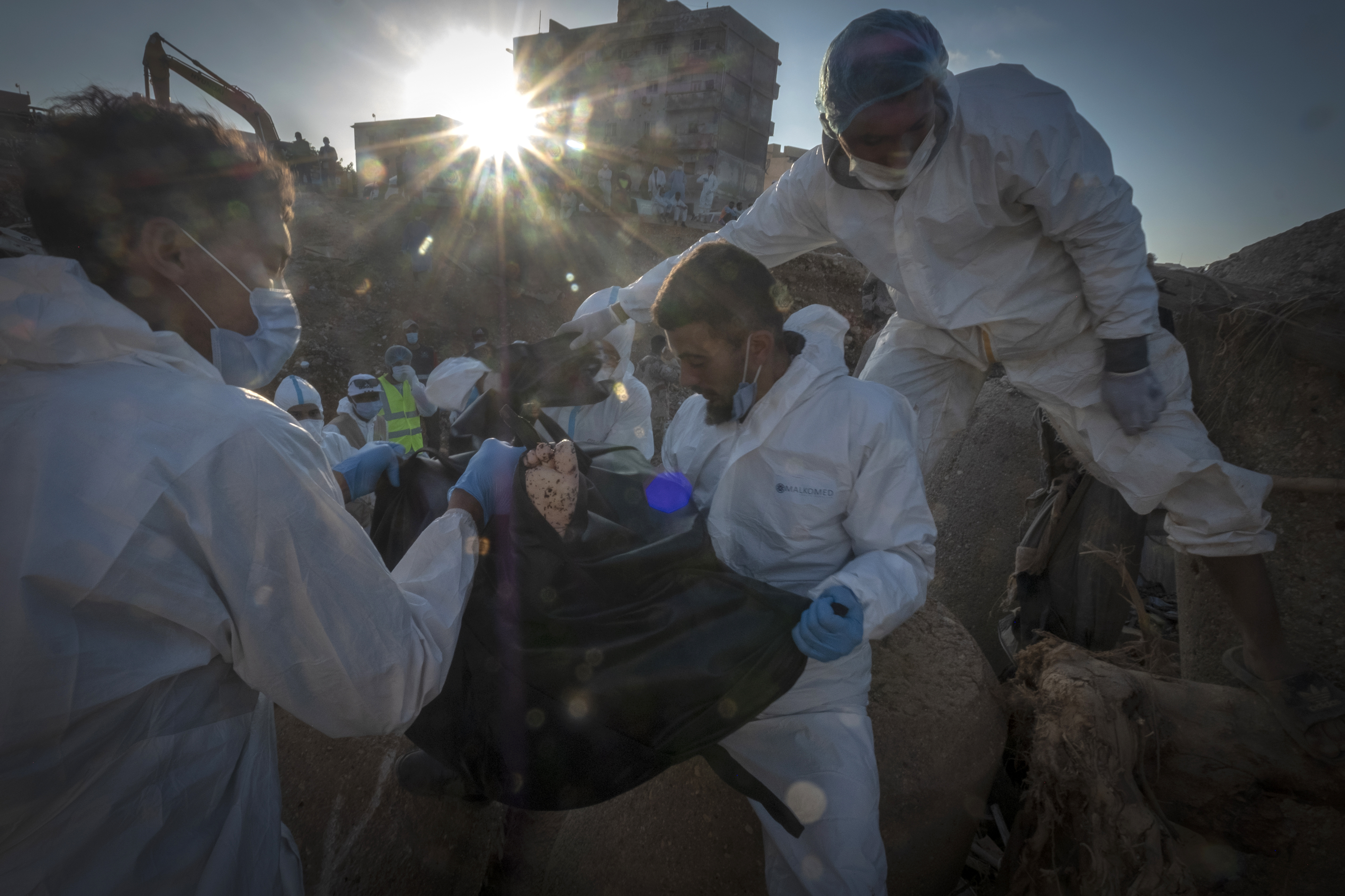 Rescuers recover the body of a victim killed during flooding in Derna, Libya.