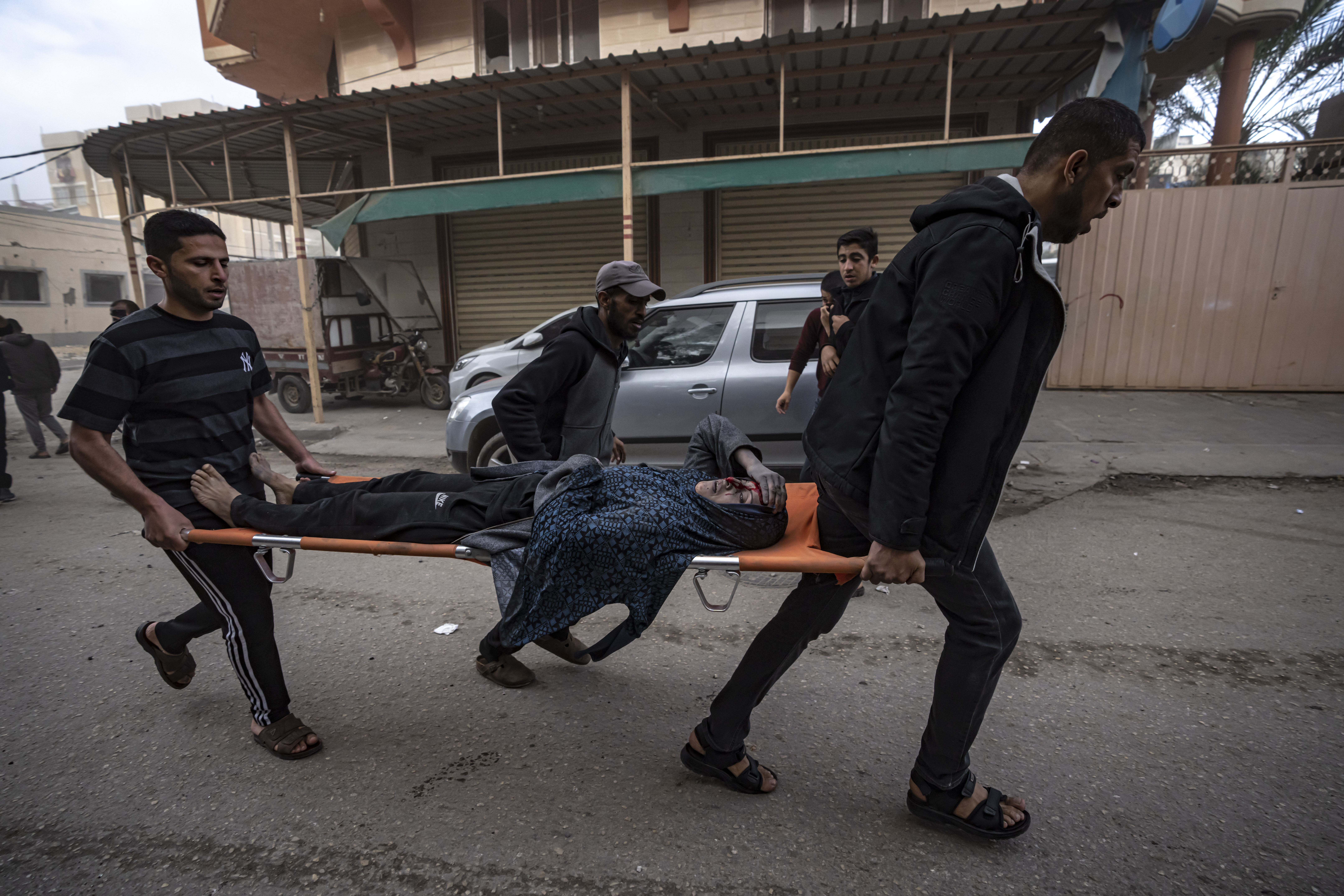 Palestinians evacuate a wounded woman from a site hit by an Israeli bombardment on Rafah, southern Gaza Strip.