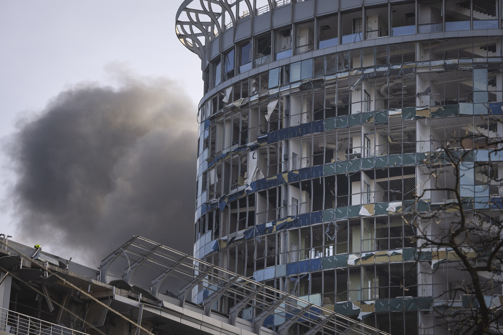 Smoke rises near a damaged building following a Russian strike in Kyiv