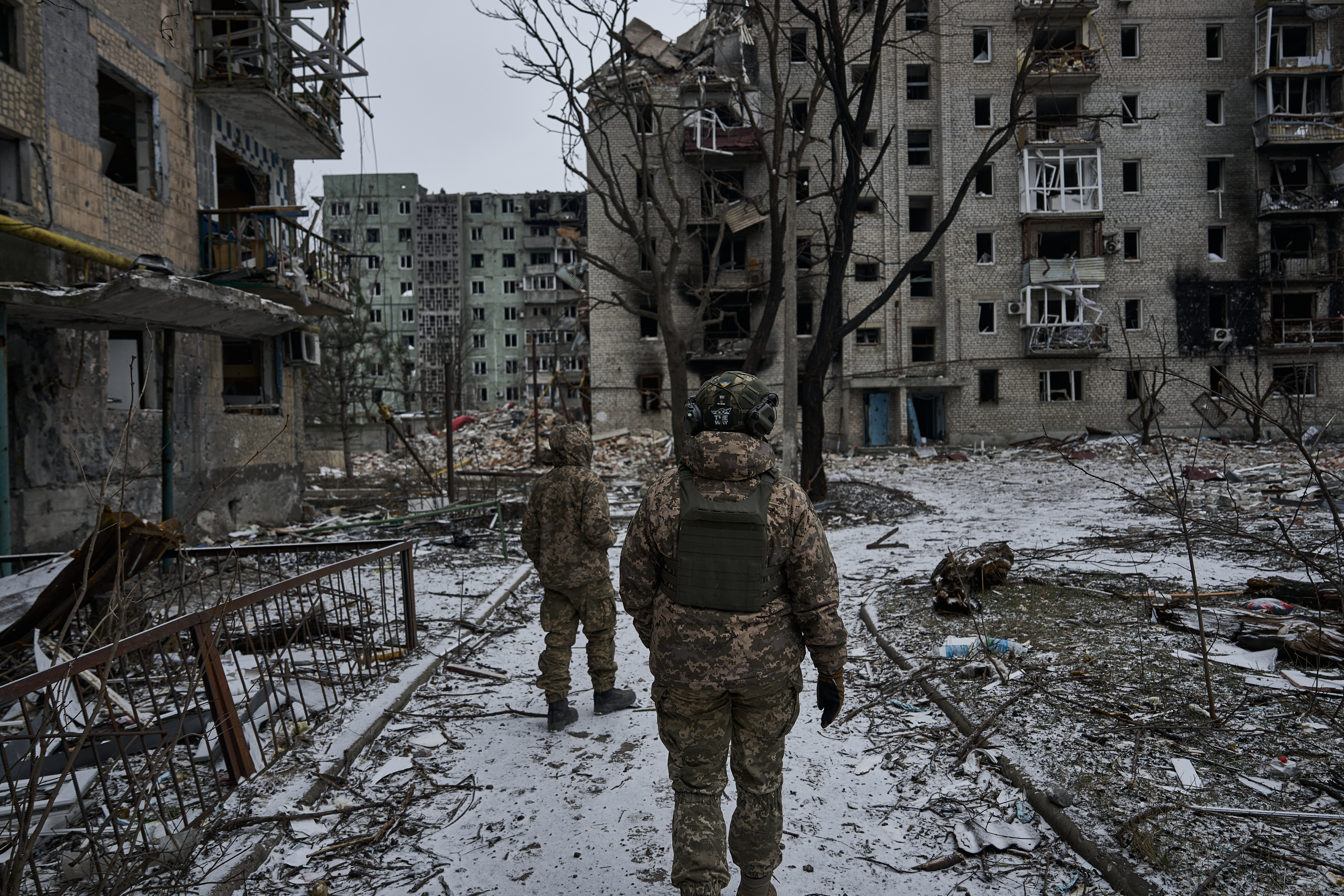 Ukrainian soldiers walk through the crater-ridden town of Avdiivka, which is now almost surrounded by Russian forces, on December 7, 2023