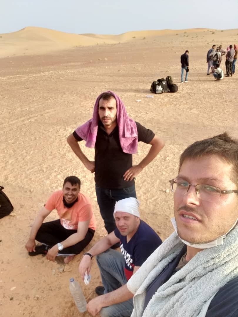 Ramy, Anas Al-Darwish, and two other Syrians, Mohammad Al Jouf and Mohammad Kabarti, in the Libyan desert [Courtesy of Rania Abu Aoun]