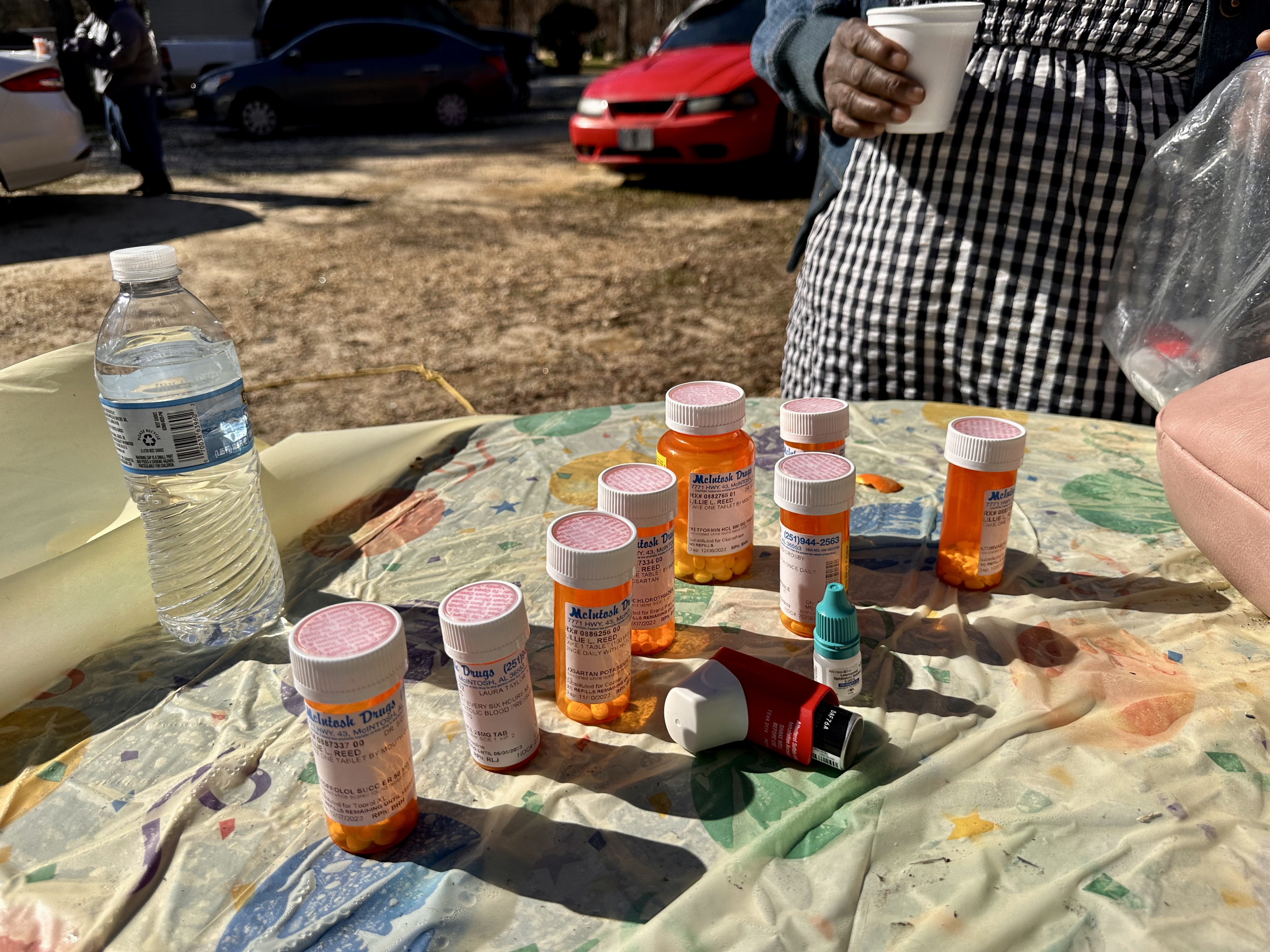 Andy Lang's sister, Lillie Lang-Reed, shows the medication she takes