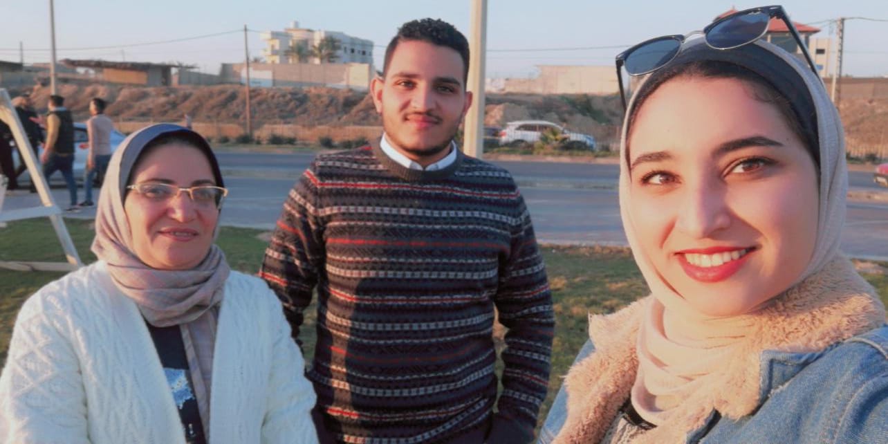 In happier times, Rania Sakallah (left) and her 22-year-old twin children Mohammed (centre) and Rana (right) on Gaza City’s al-Rasheed Street. Before the war, Mohammed and Rana were about to embark on their final year of university studies [Courtesy of Rania Sakallah]