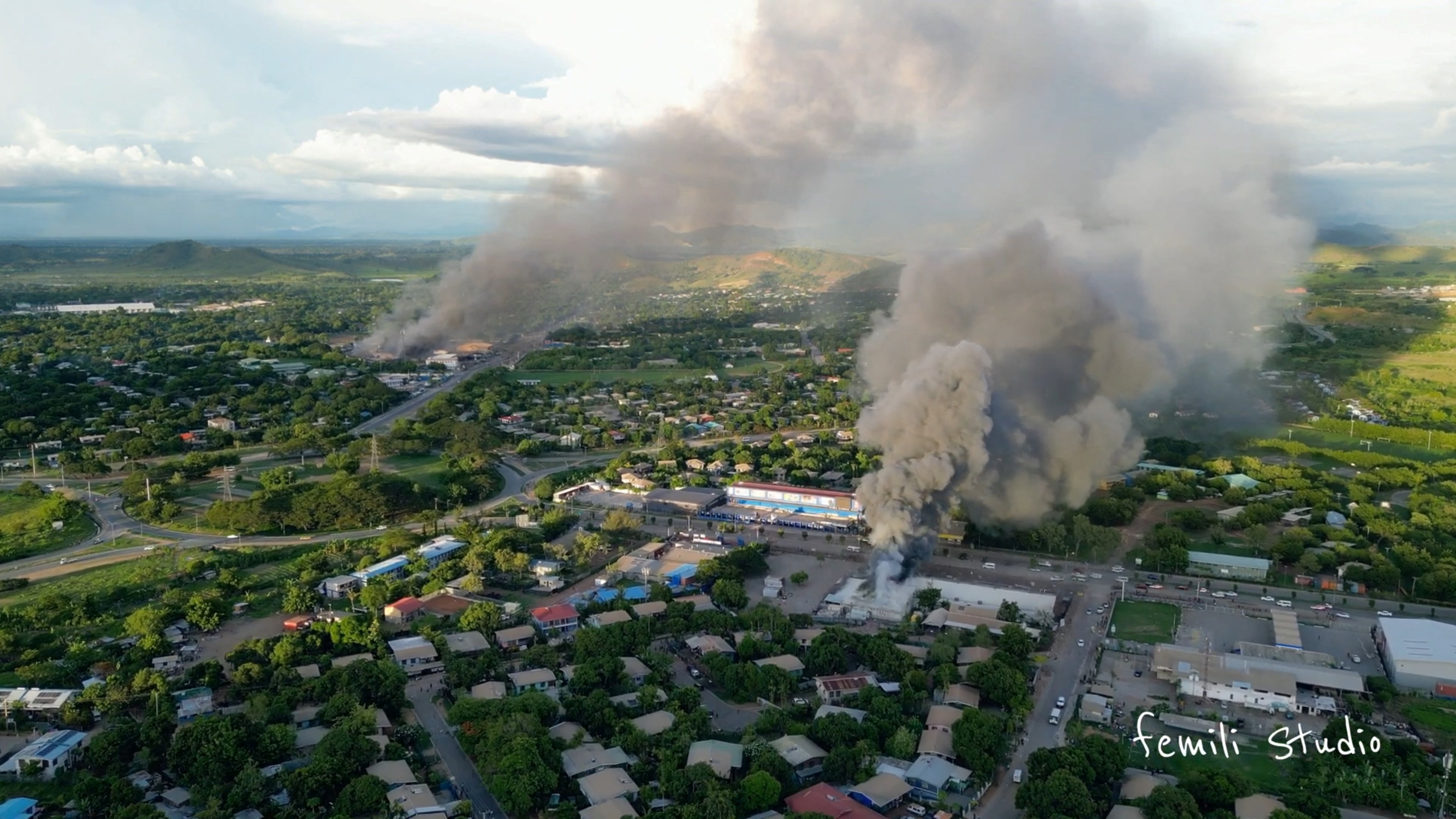 An aerial view of smoke billowing from buildings set alight during Wednesday’s unrest [Femli Studio via Reuters]