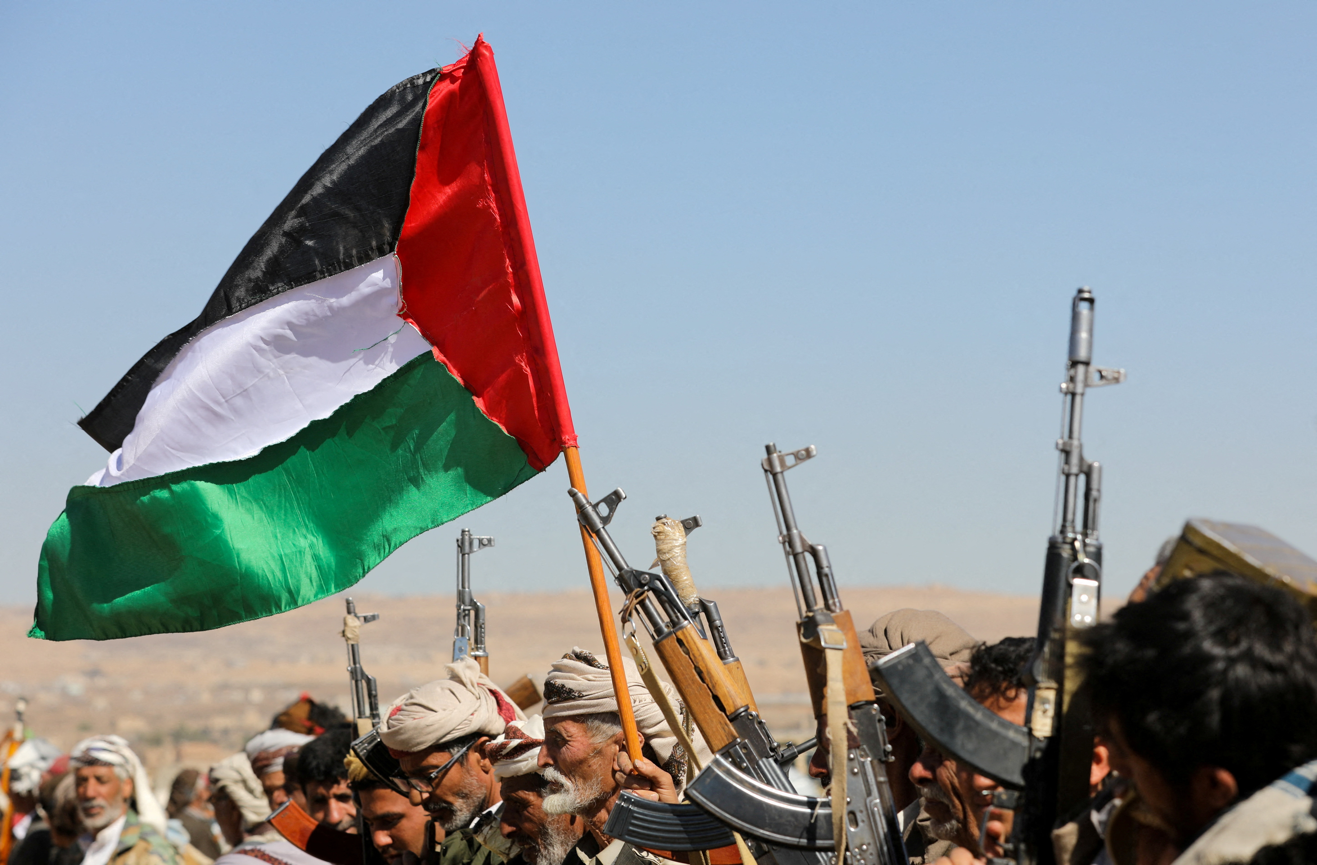 Houthi supporters wave a Palestinian flag during a protest against recent US-led attacks, near Sanaa, Yemen January 14, 2024