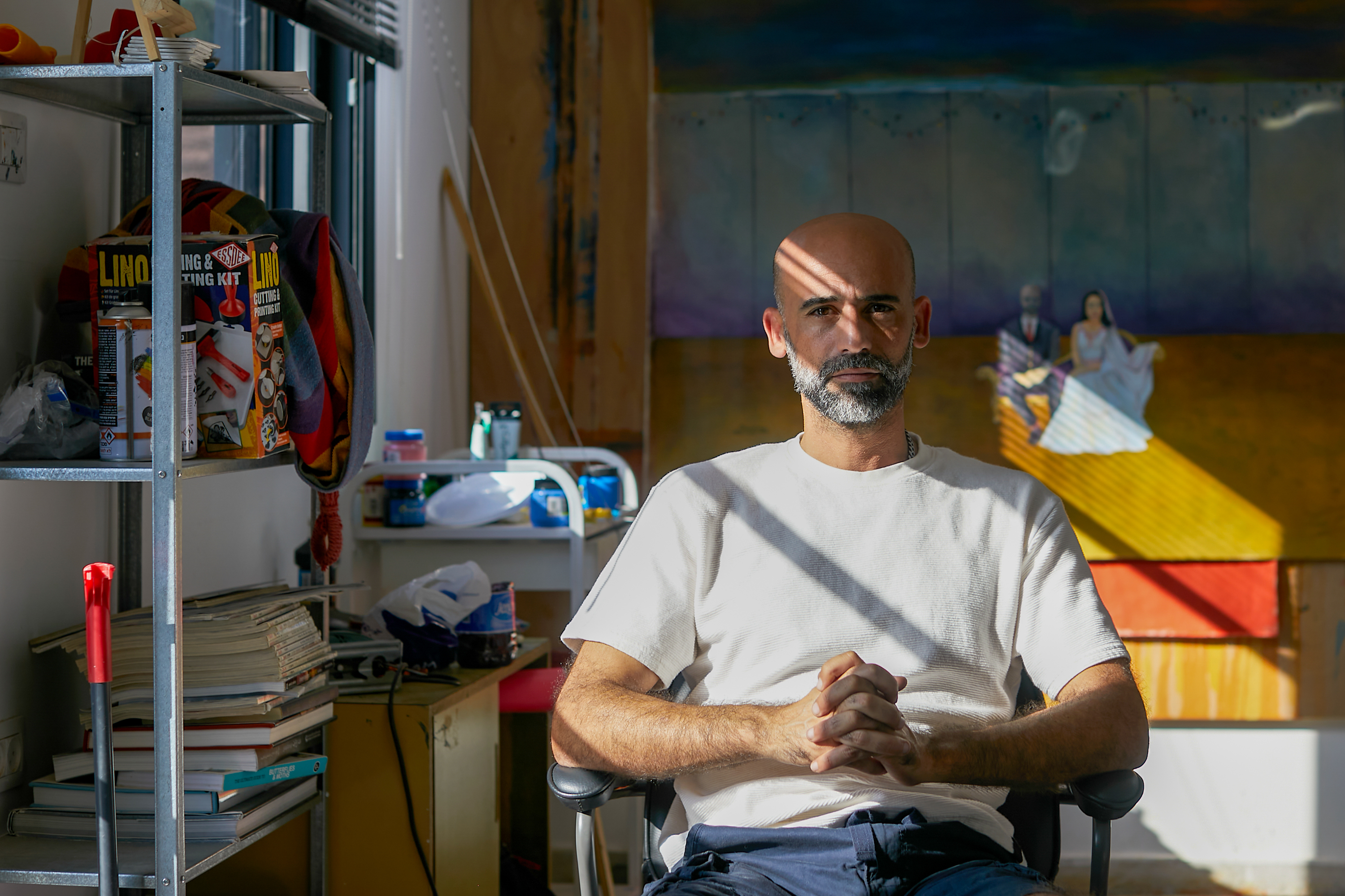 Ahed in white shirt and blue shorts in his studio