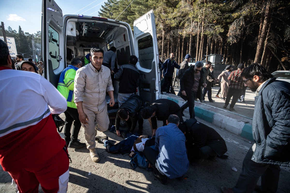 Iranian emergency services arrive at the site where two explosions in quick succession struck a crowd marking the anniversary of the 2020 killing of Guards general Qasem Soleimani, near the Saheb al-Zaman Mosque in the southern Iranian city of Kerman