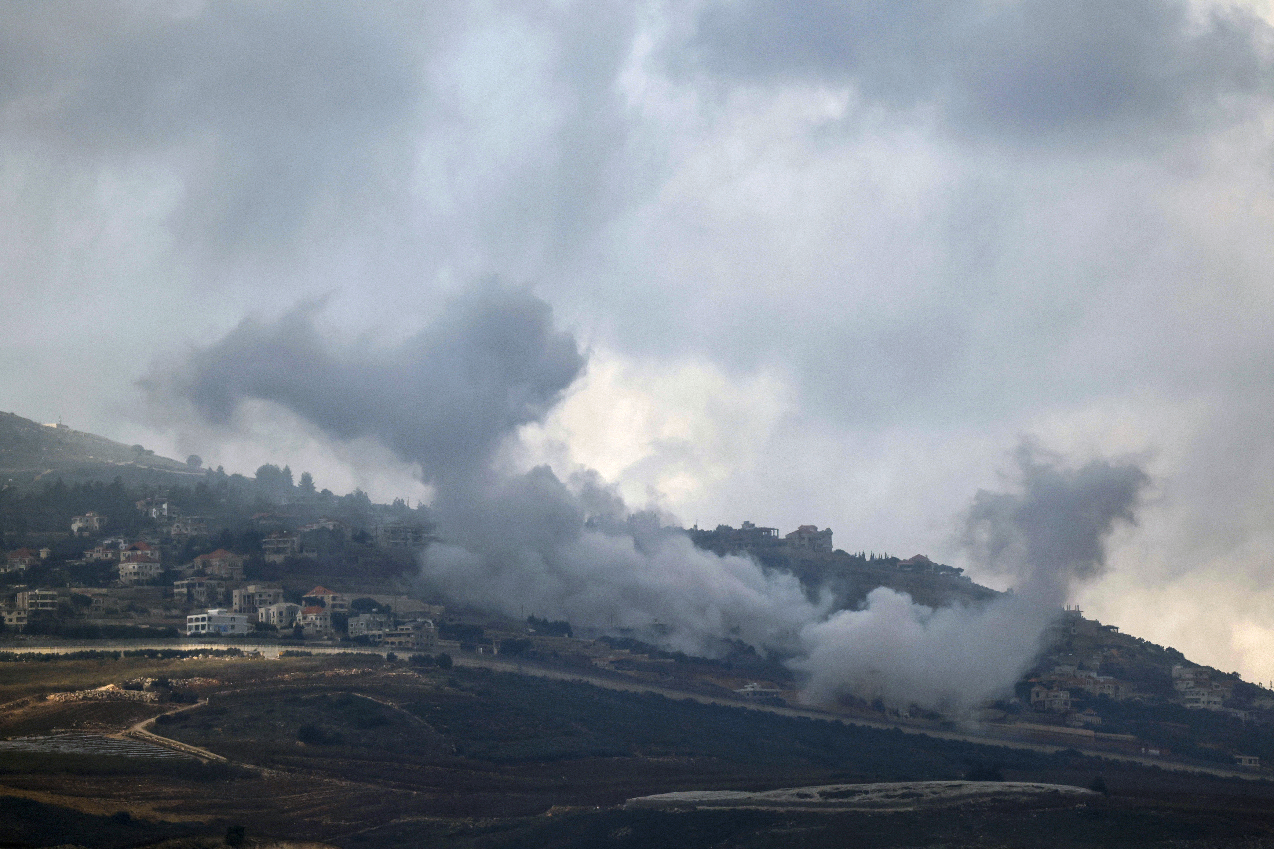 This picture taken from an Israeli position along the border with southern Lebanon, shows smoke billowing above the village of Adayseh during Israeli bombardment on January 4
