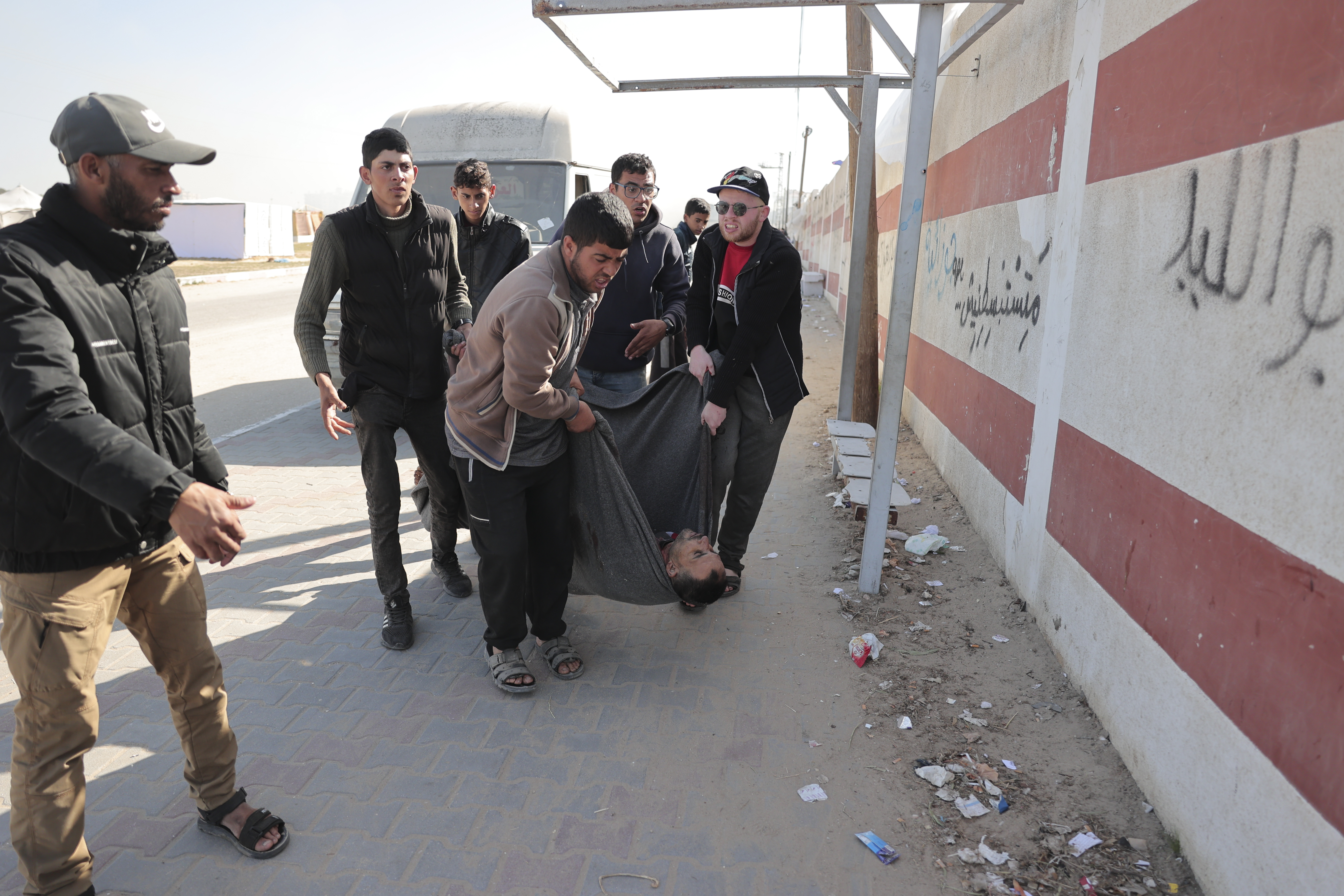 Palestinians carry an injured man as they flee Khan Younis to escape the Israeli ground and air offensive on the Gaza Strip, on Monday, January 22, 2024
