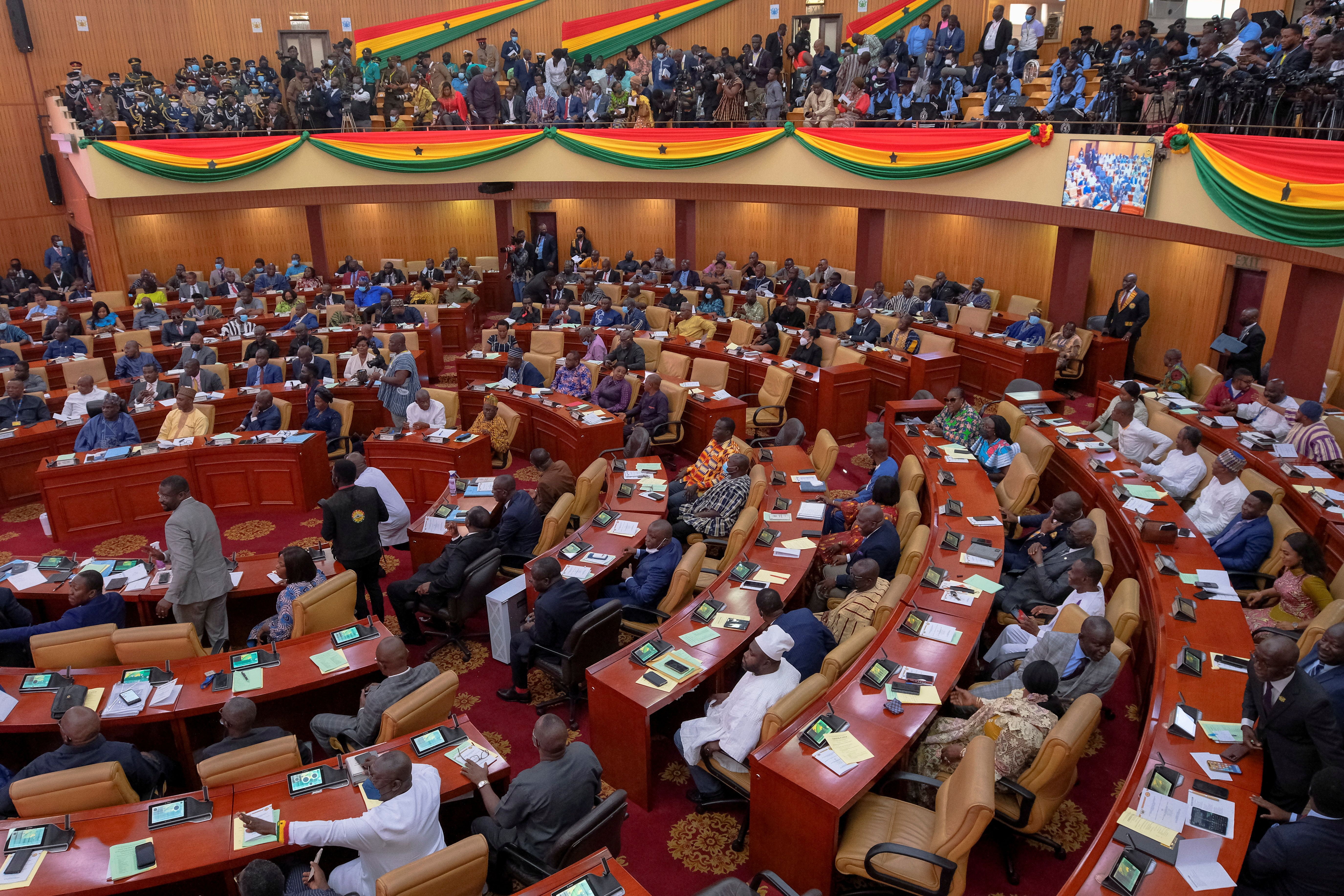 Parliamentarians and members of the public listen as Ghanaian President Nana Akufo-Addo delivers his annual state of the nation address to the parliament in Accra, Ghana, March 30, 2022