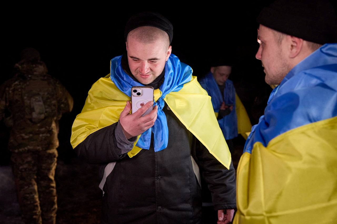 A Ukrainian prisoner of war speaks on a mobile phone after the exchange, February 8, 2024