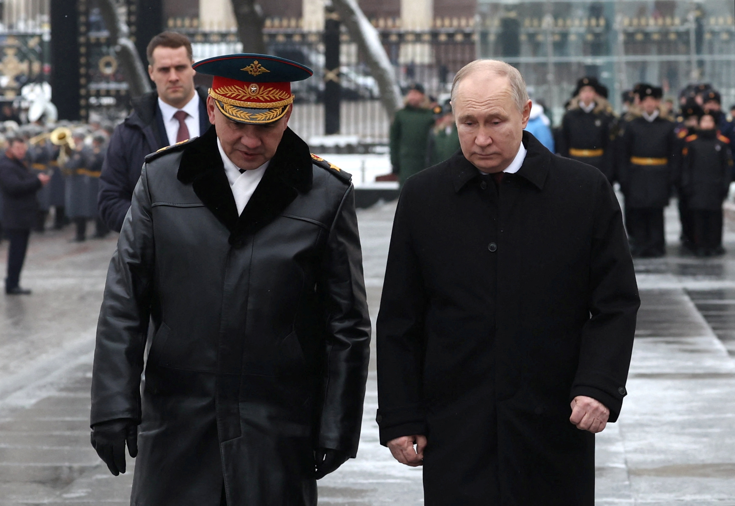 Russia's President Vladimir Putin and Defence Minister Sergei Shoigu speak after a wreath laying ceremony marking Defender of the Fatherland Day at the Tomb of the Unknown Soldier by the Kremlin Wall in Moscow, Russia, February 23, 2024. Sputnik/Alexander Kazakov/Pool via REUTERS ATTENTION EDITORS - THIS IMAGE WAS PROVIDED BY A THIRD PARTY.
