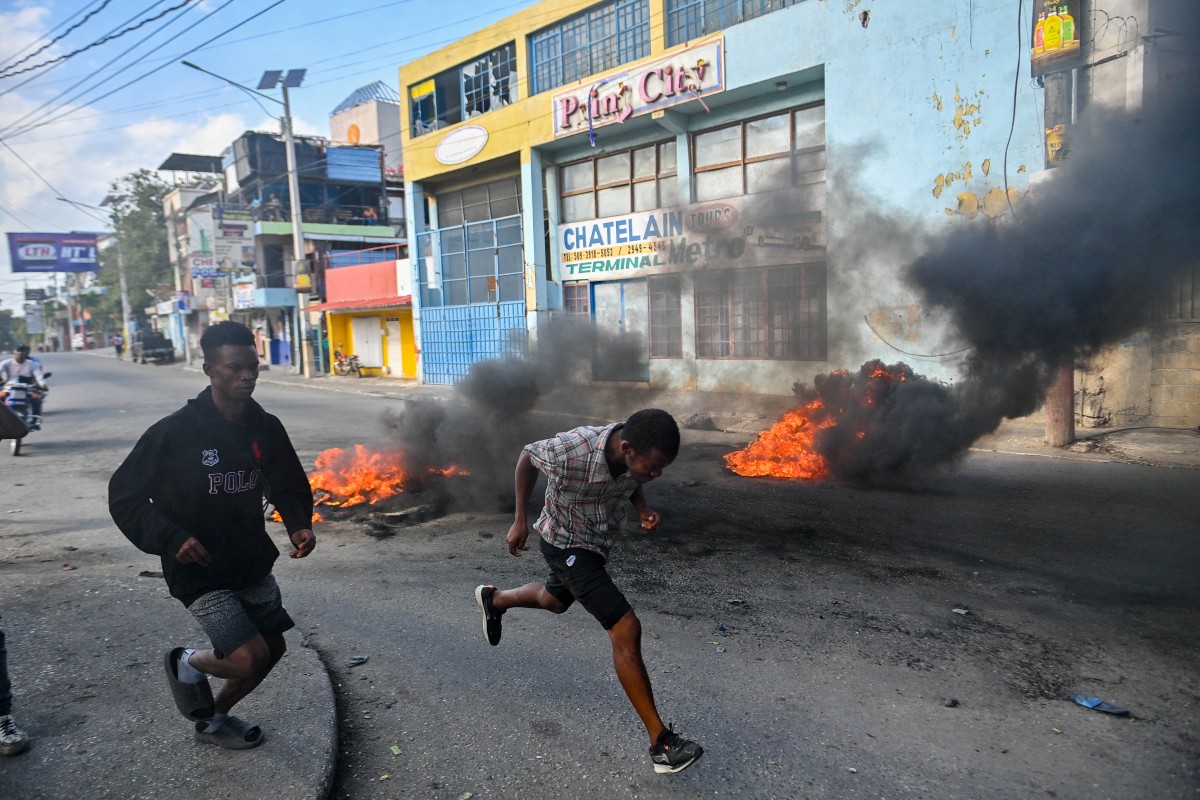 People run past burning tires