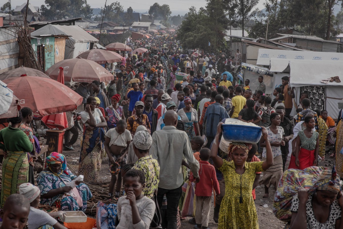 Displaced people go about their daily business west of the town of Goma, in eastern DRC