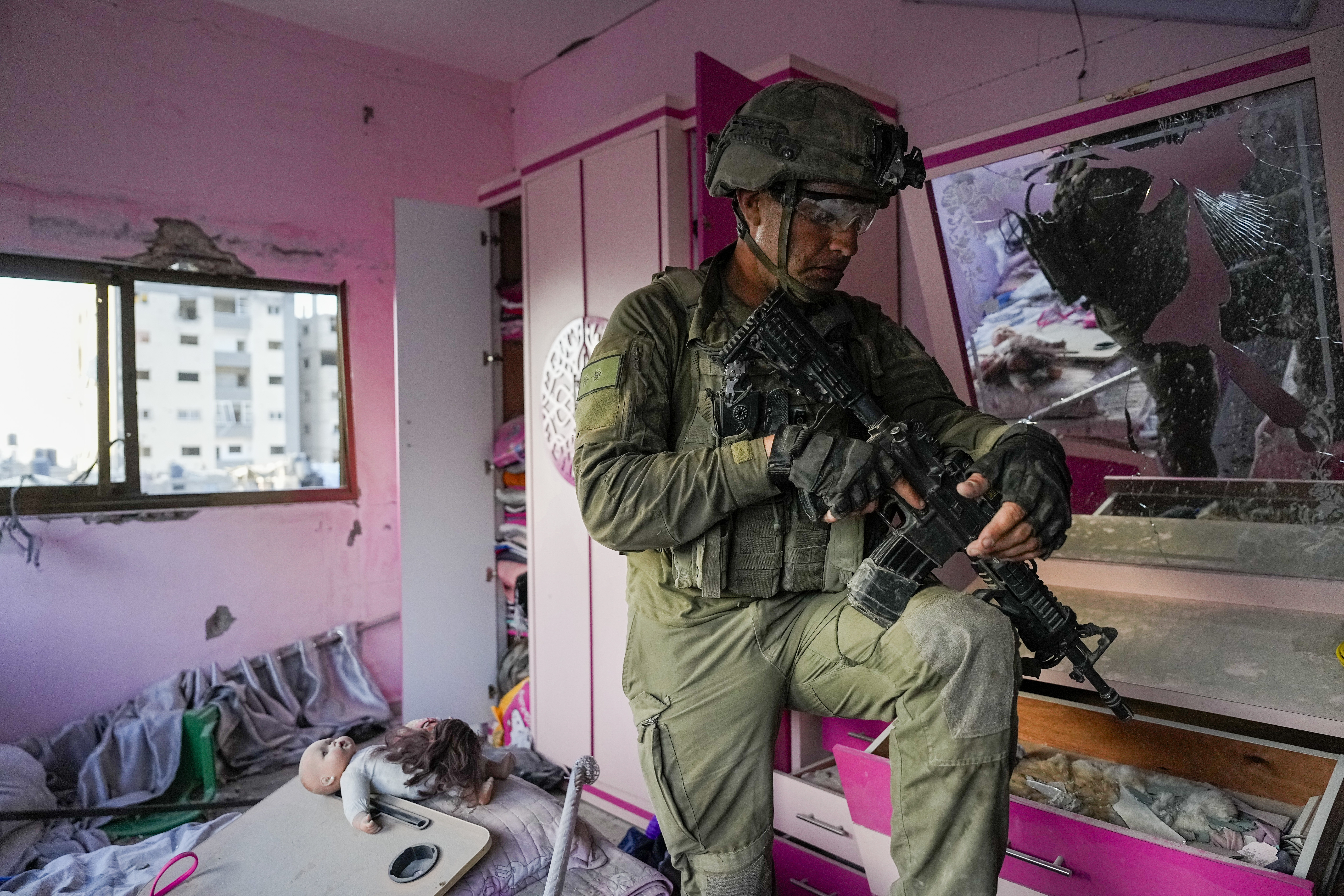 An Israeli soldier stands in an apartment during a ground operation in the Gaza Strip, on Wednesday, November 8, 2023