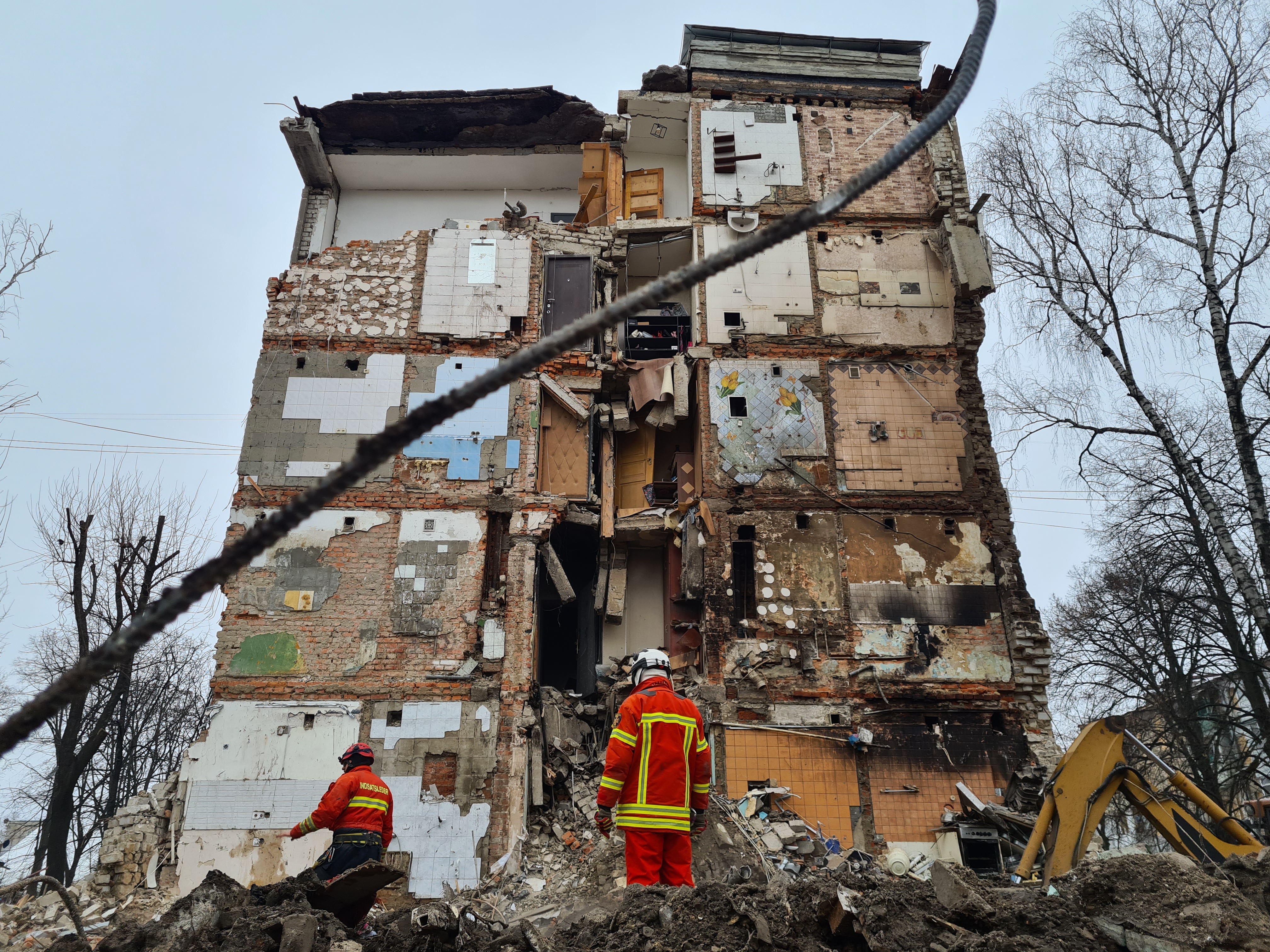 Rescue teams work in Kharkiv after Russian bombing on January 24. Many people fleeing will have no homes to return to