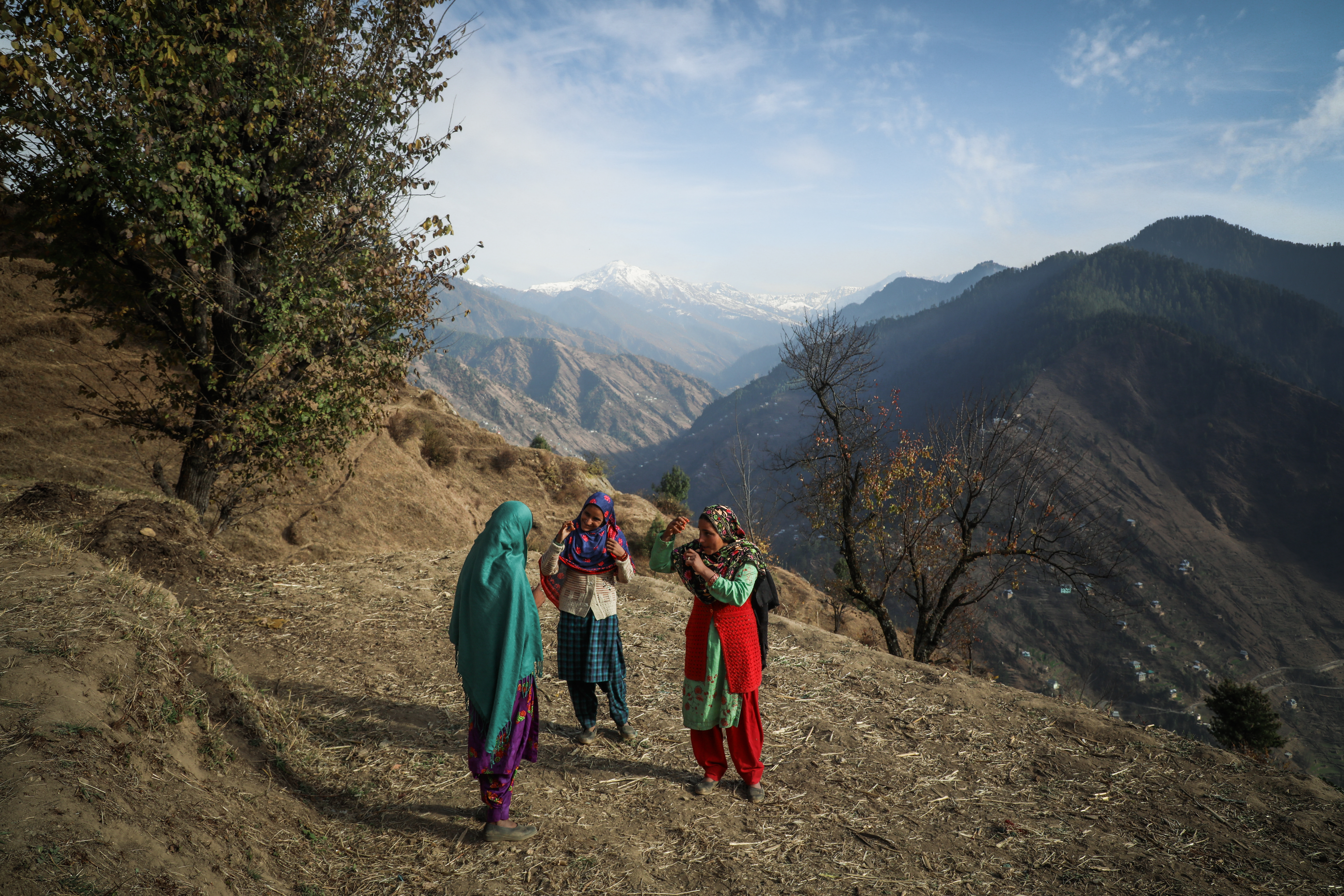 Sisters Aisha Banu, 23, right, Asra Banu,13, centre and Reshma Banu, 15, left, communicate with each other using gestures