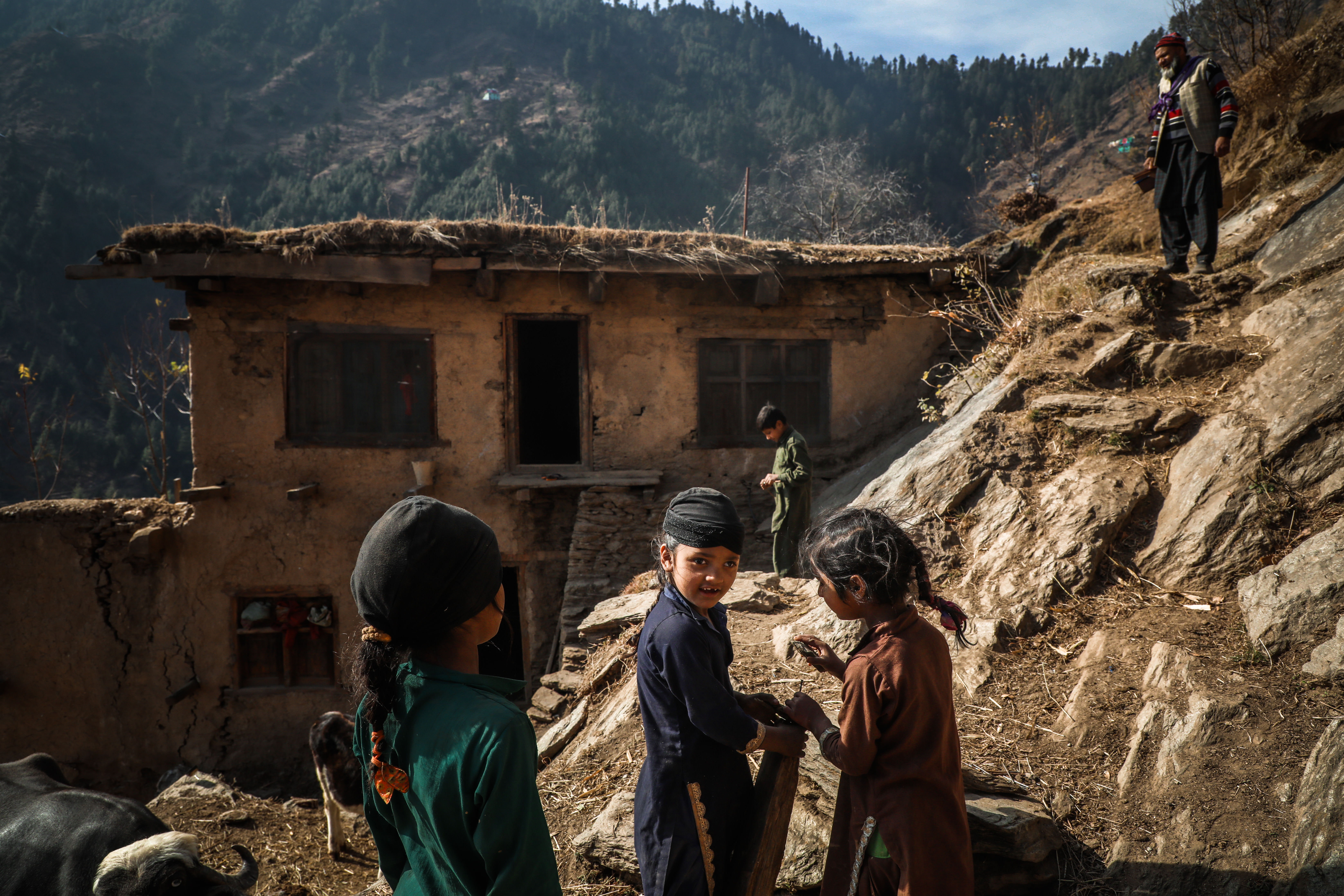 The children of Reham Ali, who is deaf and mute, play in the courtyard of their house