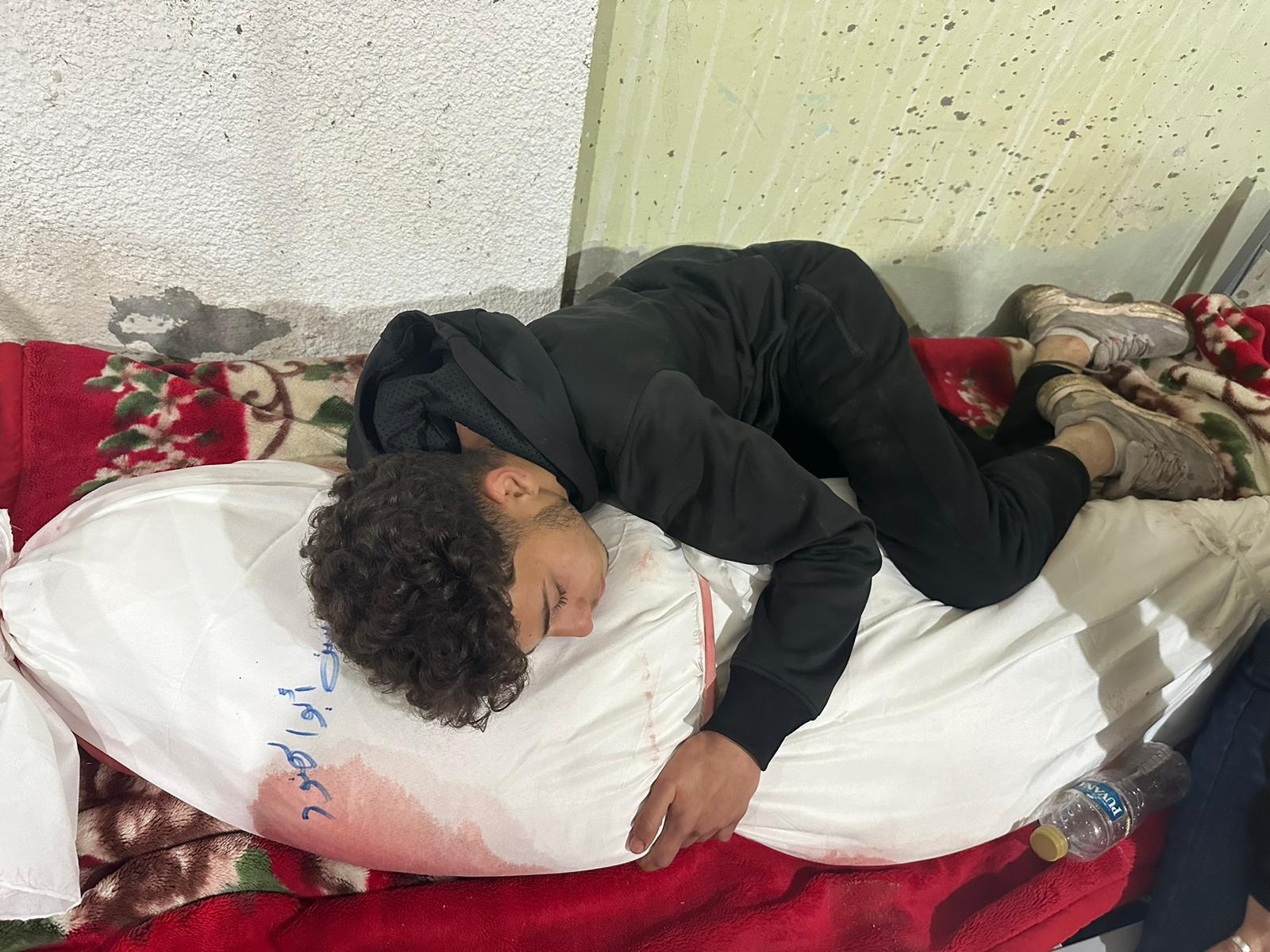 The photo of Shehab Omar Abu al-Hanud unable to let go of his mother’s shrouded body broke hearts everywhere