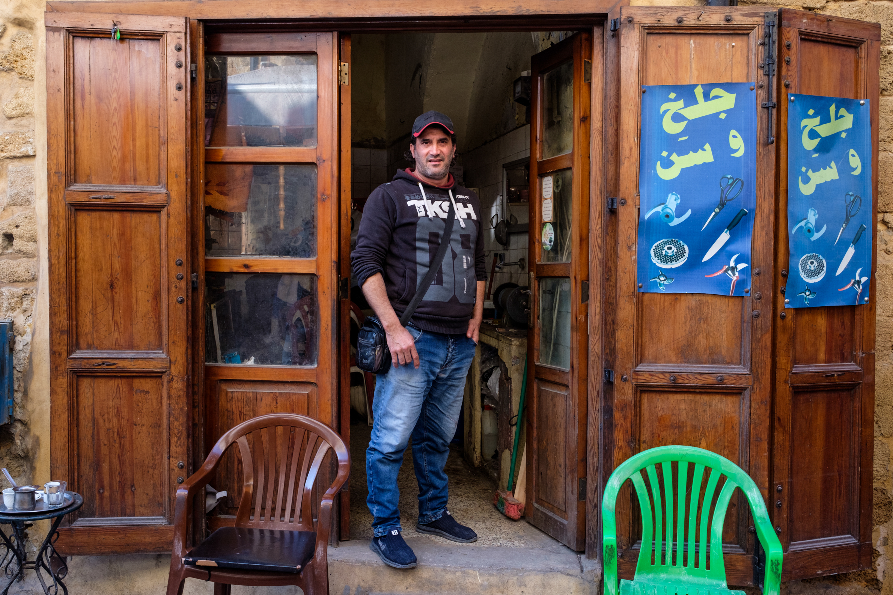 Marwan in front of his shop – where he also offers knife-sharpening services