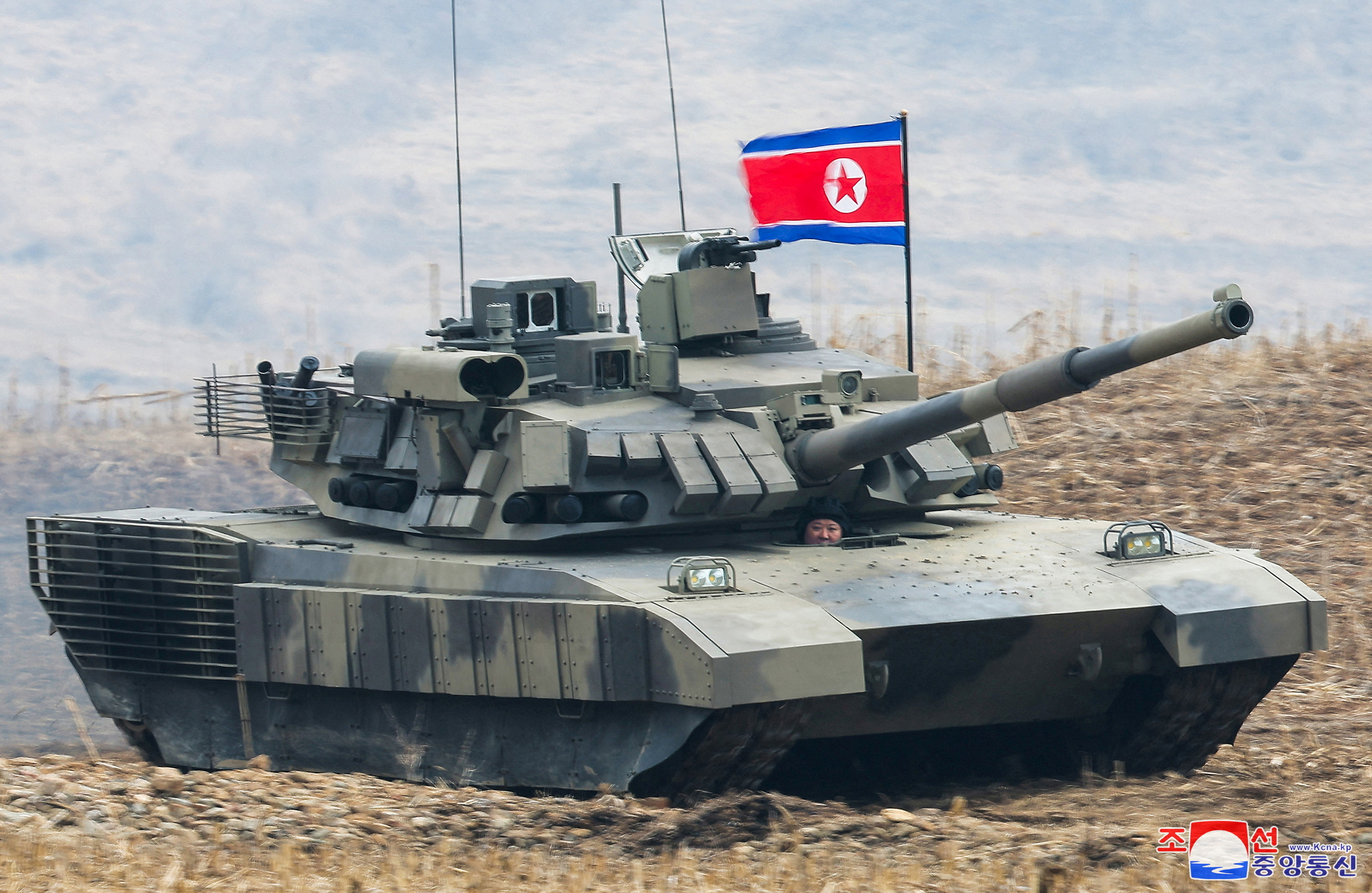 North Korean leader Kim Jong Un guides a military demonstration involving tank units