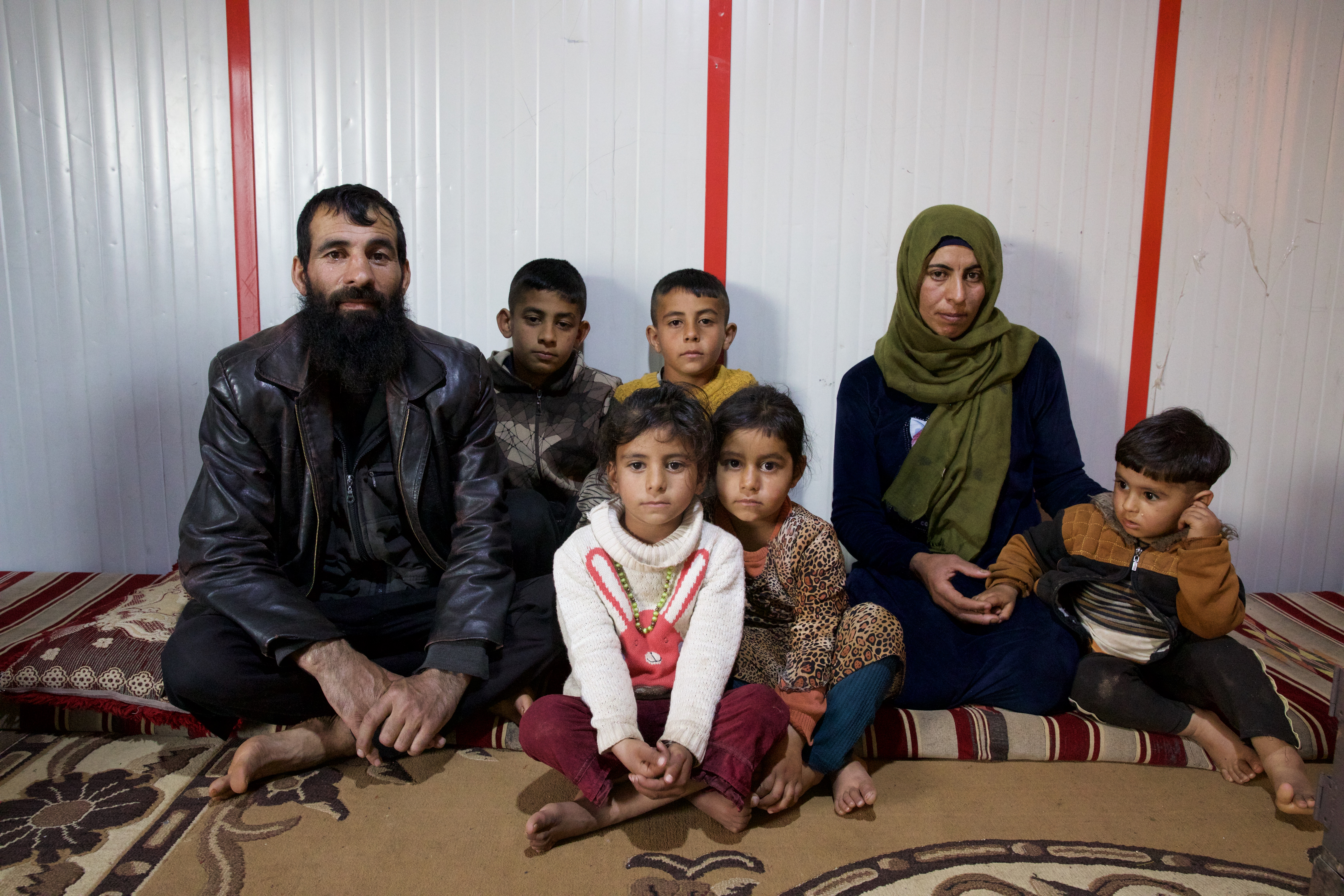 Khaled, left, next to 10-year-old Hisham and eight-year-old Ahmed with six-year-old Zeinab and five-year-old Khitam in front and Bayan, second from right, holding two-year-old Mosab’s hand