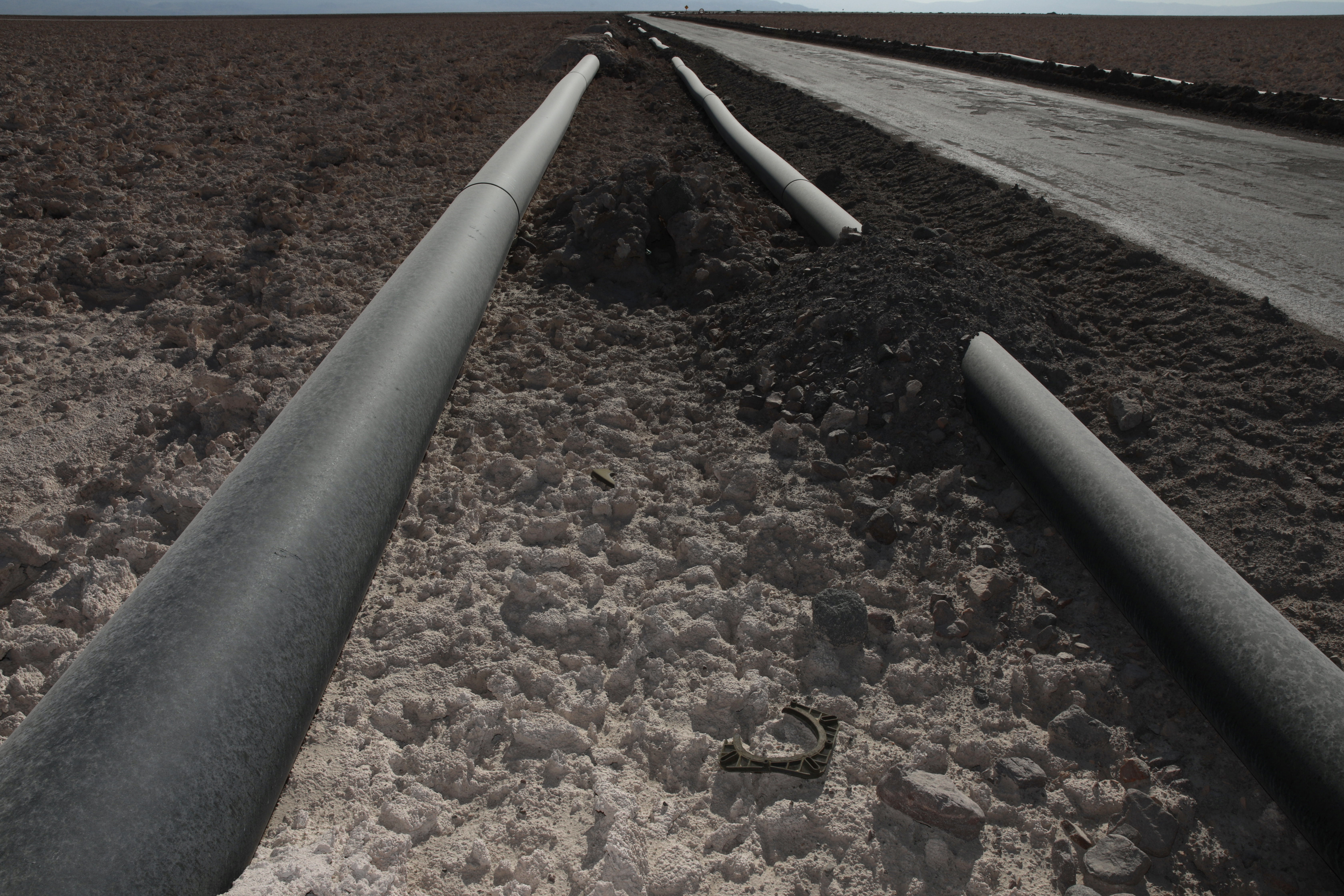 Pipes carrying millions of litres of water from the Andean mountains to the lithium production facilities of SQM in the Salar of Atacama, northern Chile